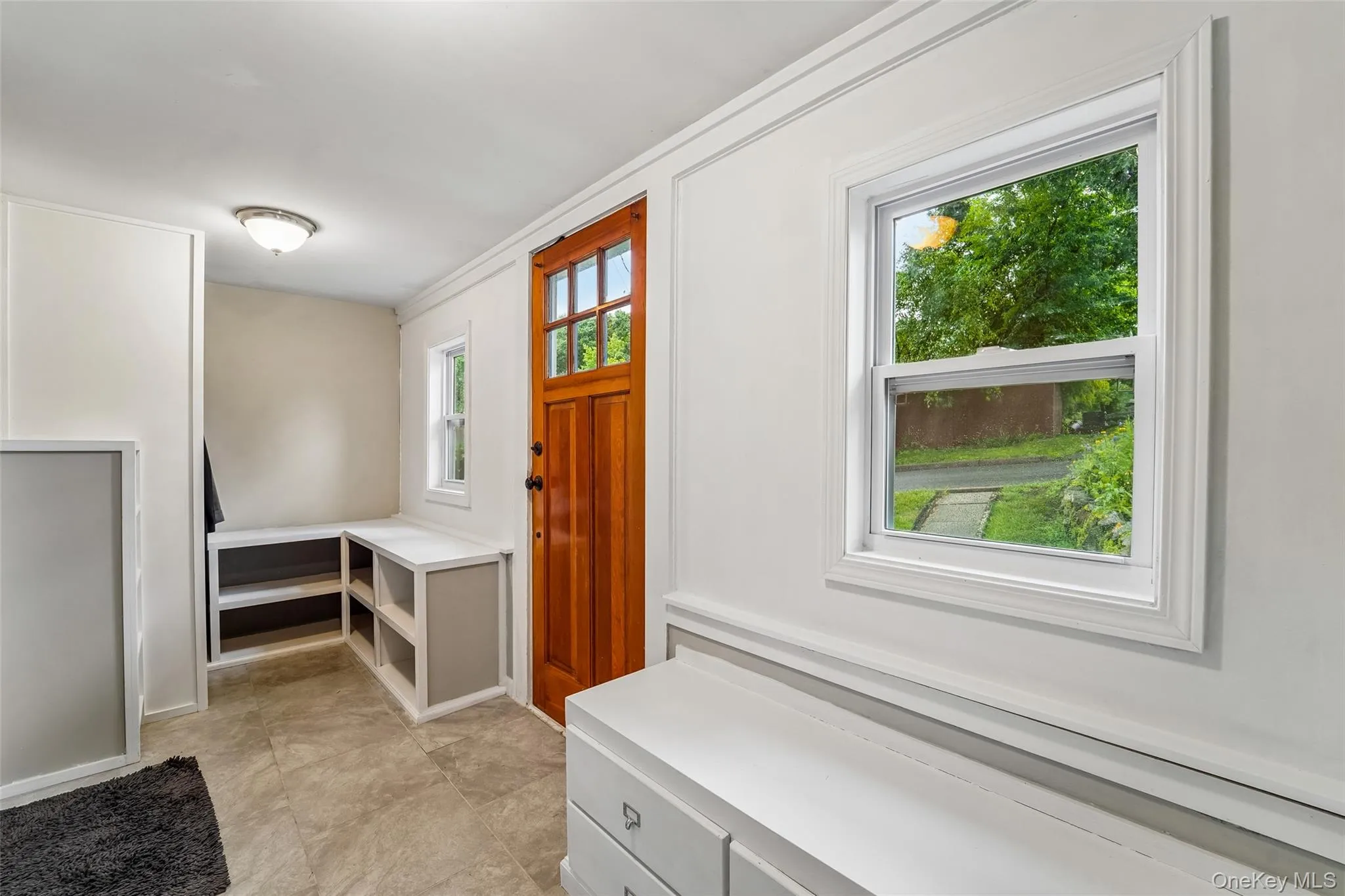 Entry foyer with bench storage. Entry foyer with bench storage.