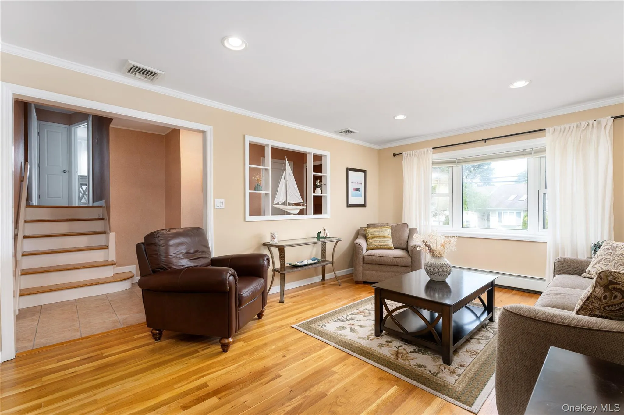 Hardwood flooring, recessed lighting, crown molding, and a built-in wall niche with shelving Hardwood flooring, recessed lighting, crown molding, and a built-in wall niche with shelving