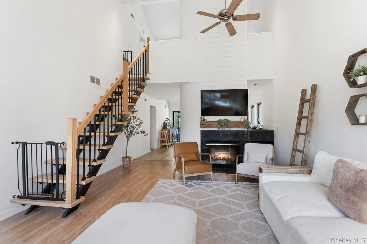 Living room with fireplace and brand new stairs to loft and office. Living room with fireplace and brand new stairs to loft and office.