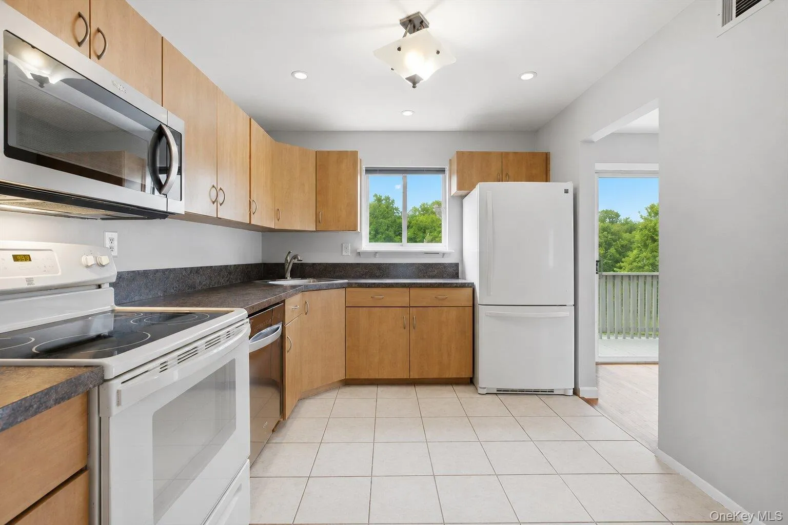 Kitchen w. Plenty of Natural Light Leading leading to Balcony and Dining Area Kitchen w. Plenty of Natural Light Leading leading to Balcony and Dining Area