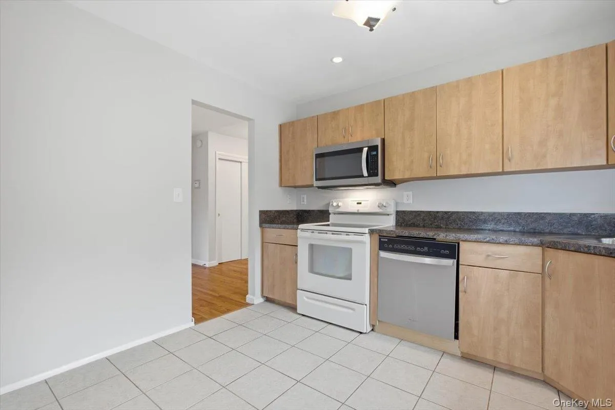 Kitchen Featuring an Electric Oven/Range, Dishwasher, Microwave and Large Refrigerator Kitchen Featuring an Electric Oven/Range, Dishwasher, Microwave and Large Refrigerator