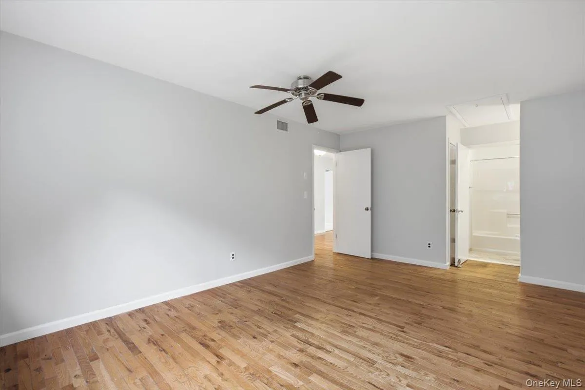 Primary Bedroom Featuring Hardwood Floors Primary Bedroom Featuring Hardwood Floors