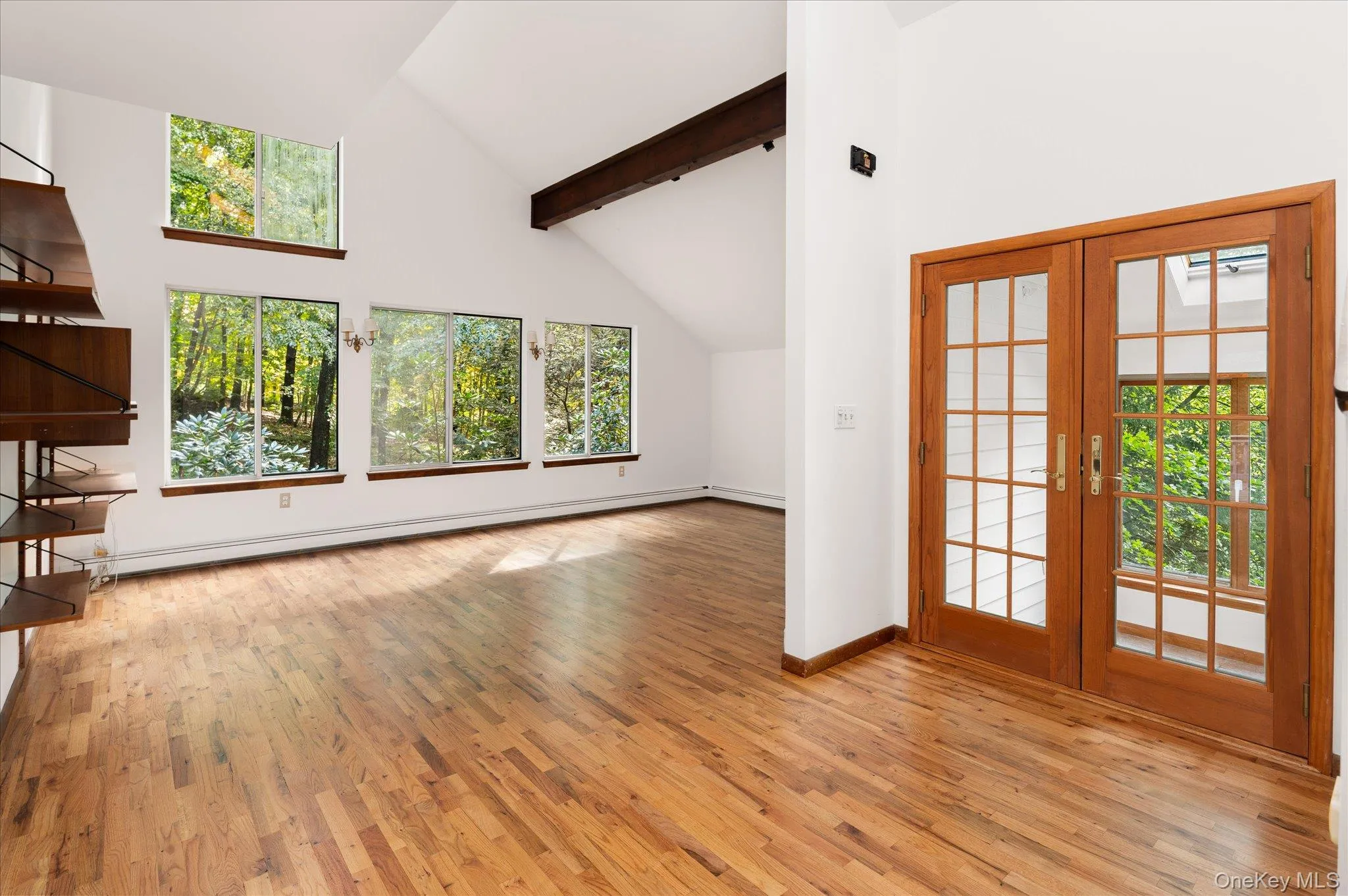 Entrance foyer with view of living room with vaulted ceiling Entrance foyer with view of living room with vaulted ceiling