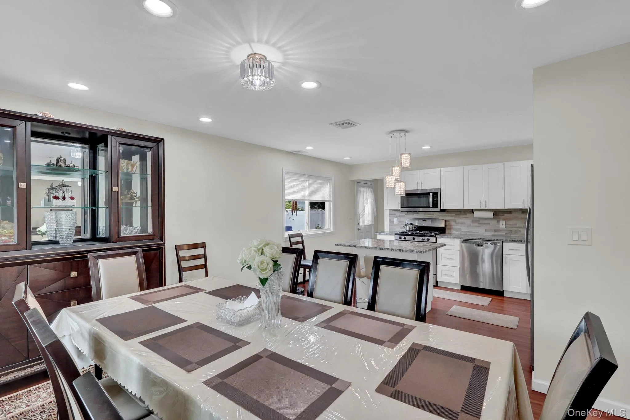 Dining area featuring recessed lighting and a decorative ceiling fixture Dining area featuring recessed lighting and a decorative ceiling fixture