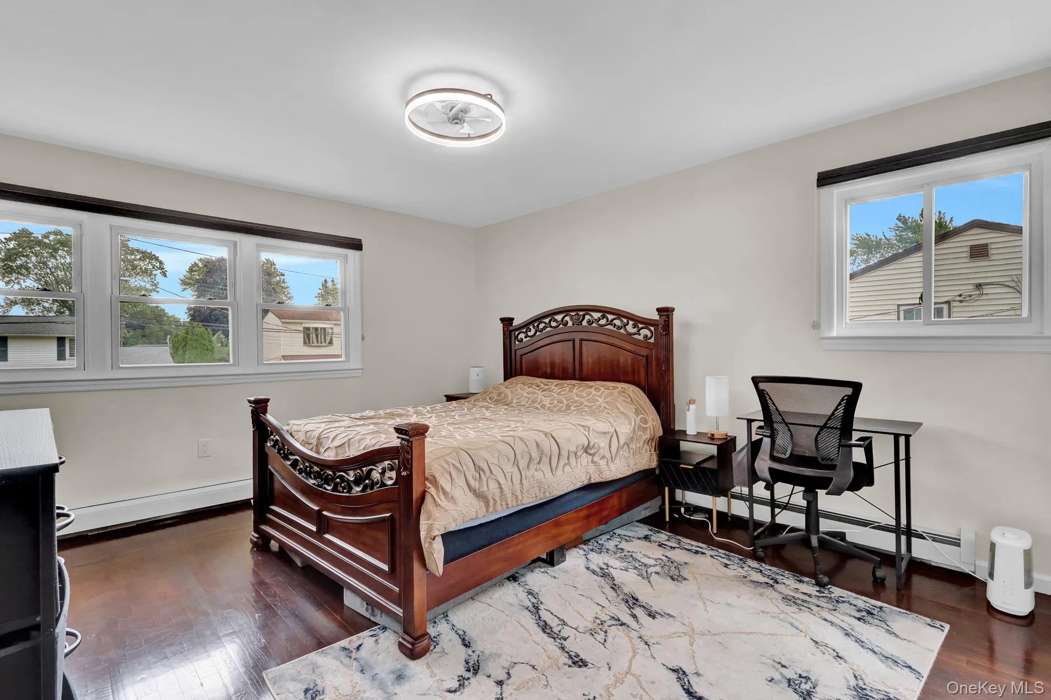 Bedroom with wood-finish flooring and light-toned walls Bedroom with wood-finish flooring and light-toned walls