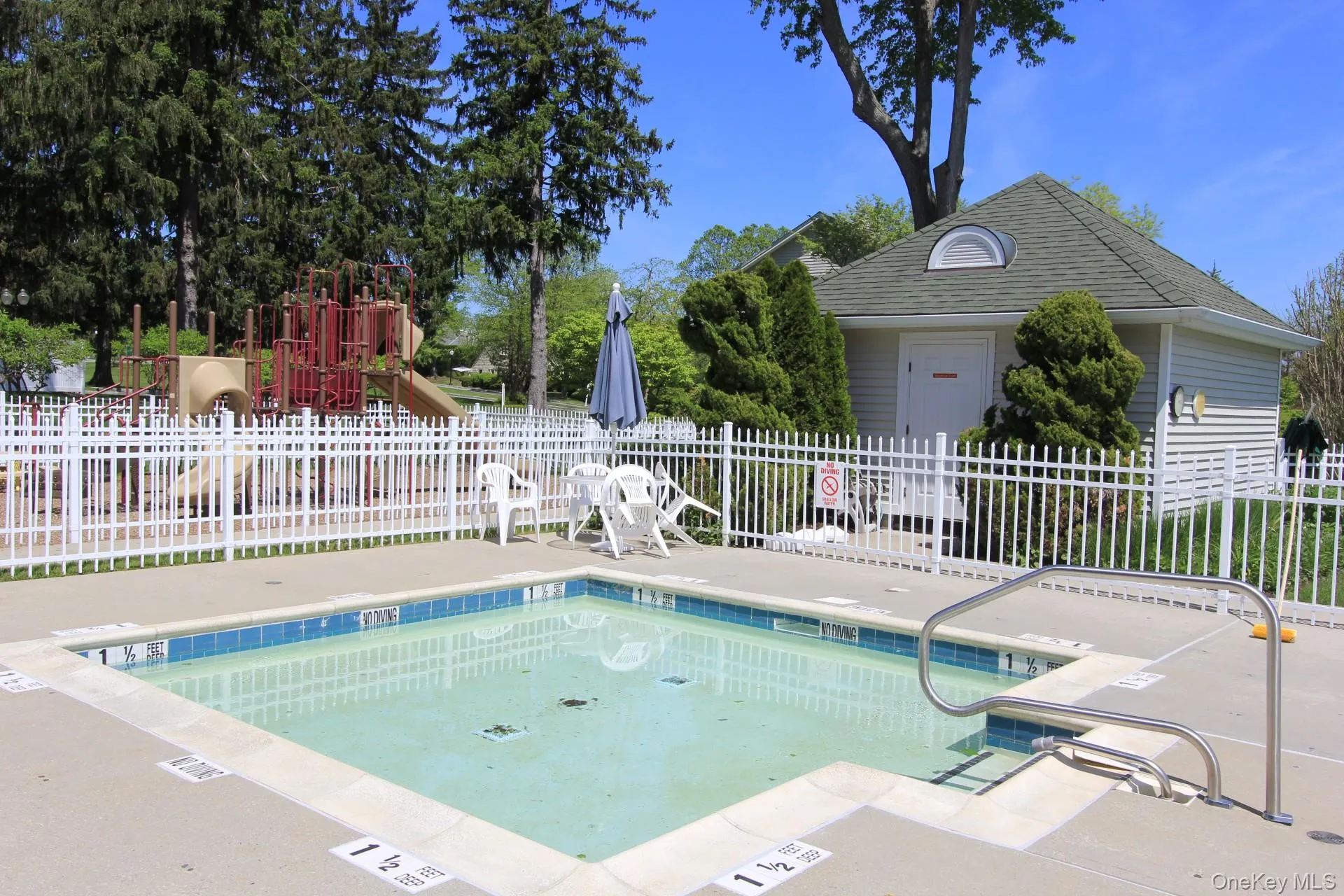 View of swimming pool with a playground and a patio area View of swimming pool with a playground and a patio area