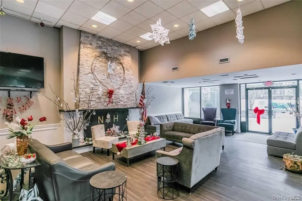 Building lobby featuring a drop ceiling, wainscoting, and recessed lighting Building lobby featuring a drop ceiling, wainscoting, and recessed lighting