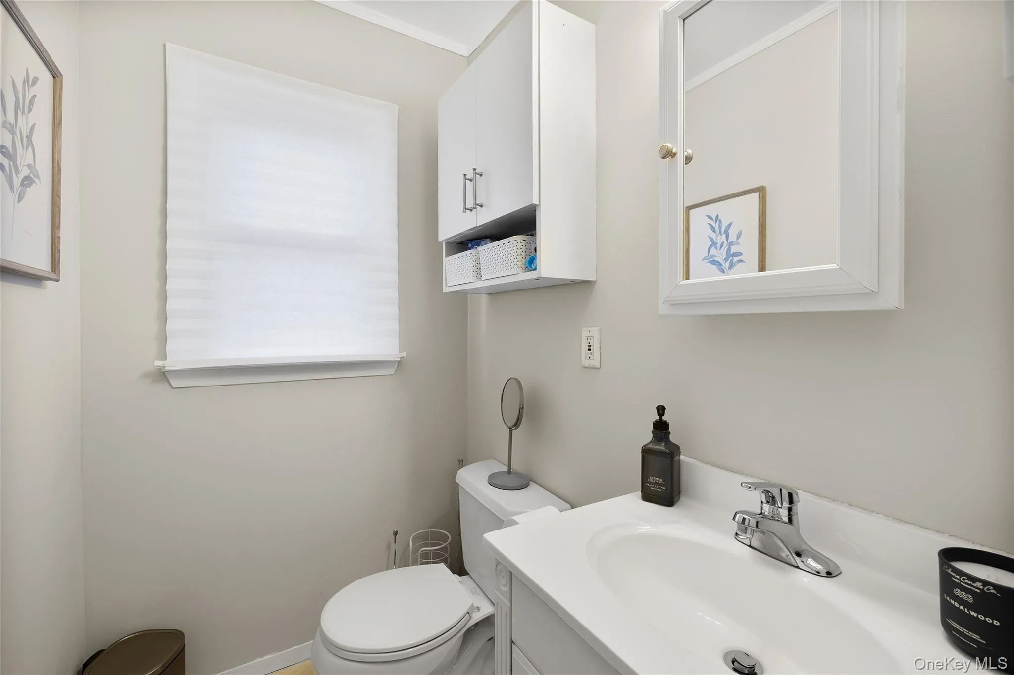 White vanity with integrated sink, chrome faucet, and framed medicine cabinet White vanity with integrated sink, chrome faucet, and framed medicine cabinet