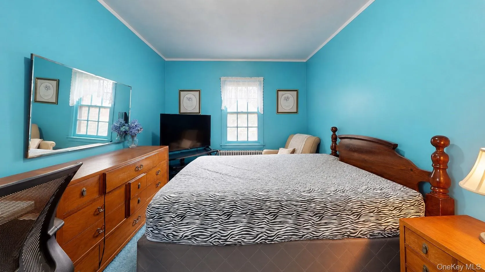 Bright room with two windows featuring white trim and white valances Bright room with two windows featuring white trim and white valances