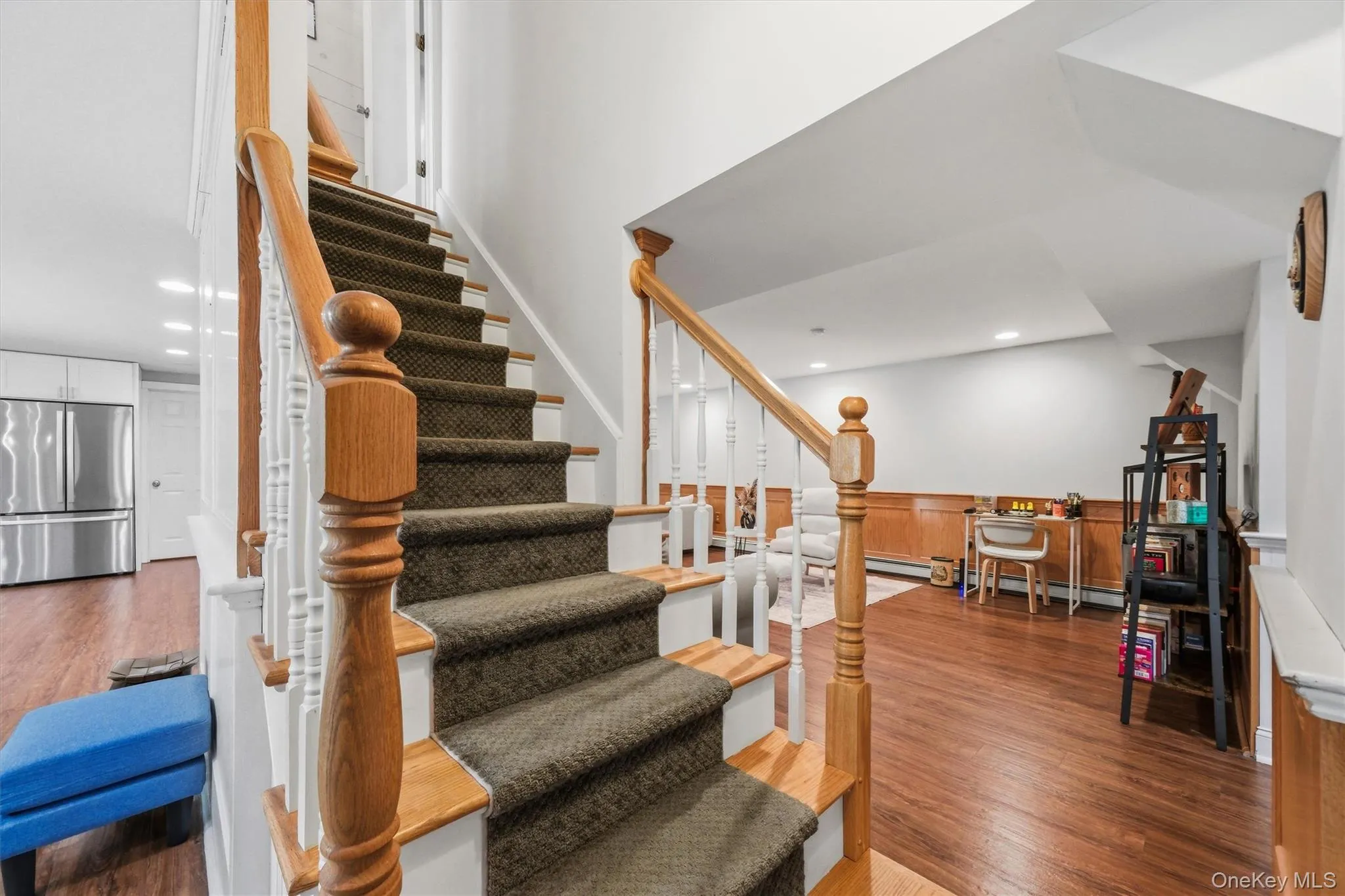 Stairs from the first floor descend to a beautifully finished basement. Stairs from the first floor descend to a beautifully finished basement.