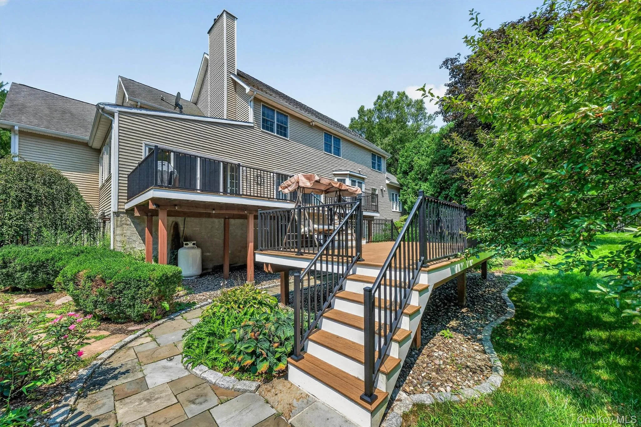 Stairs from the deck to a fenced-in pool area. Stairs from the deck to a fenced-in pool area.