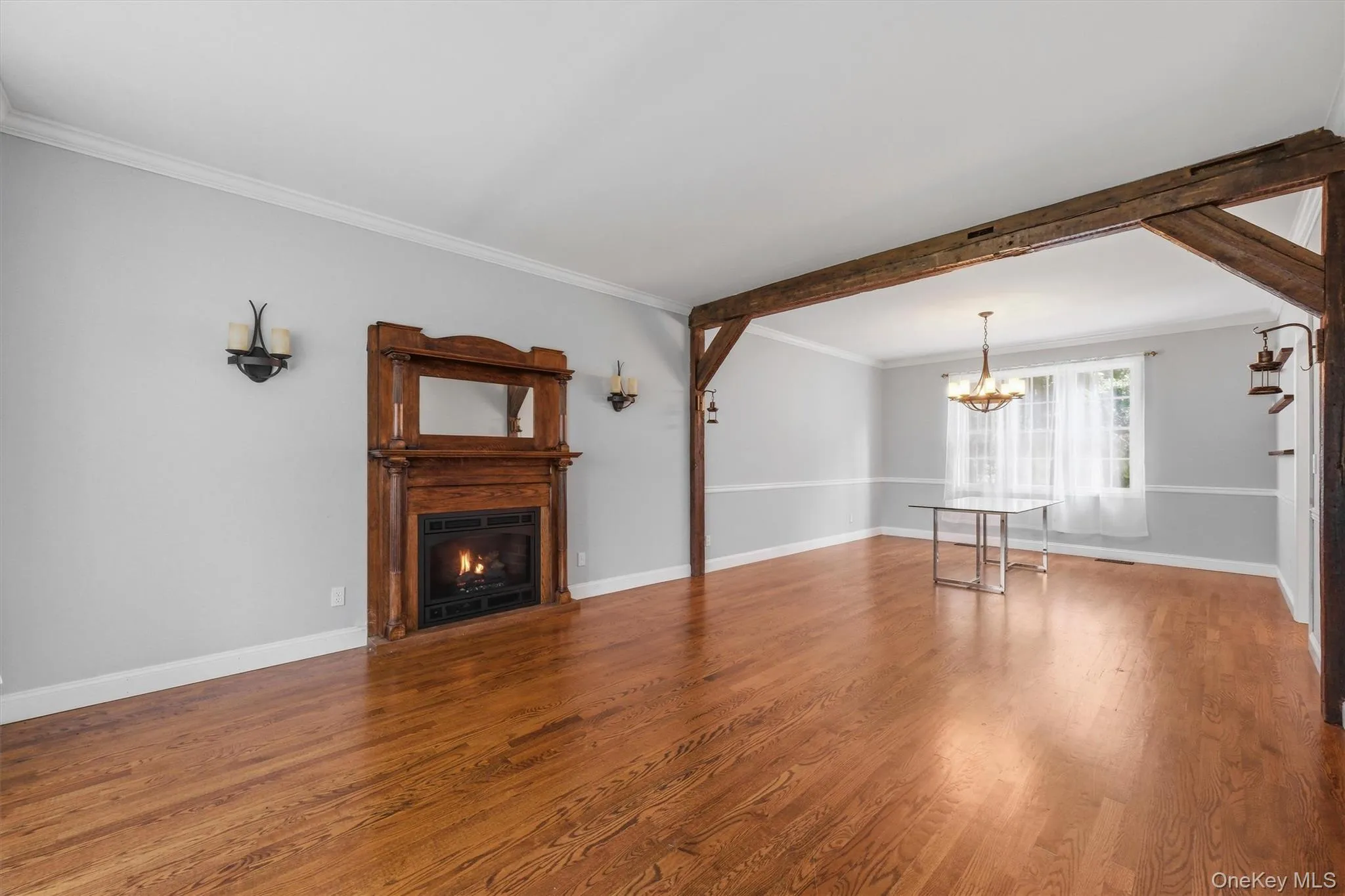 The spacious living room flows seamlessly into a formal dining room, elegantly defined by rich wood accents. The spacious living room flows seamlessly into a formal dining room, elegantly defined by rich wood accents.
