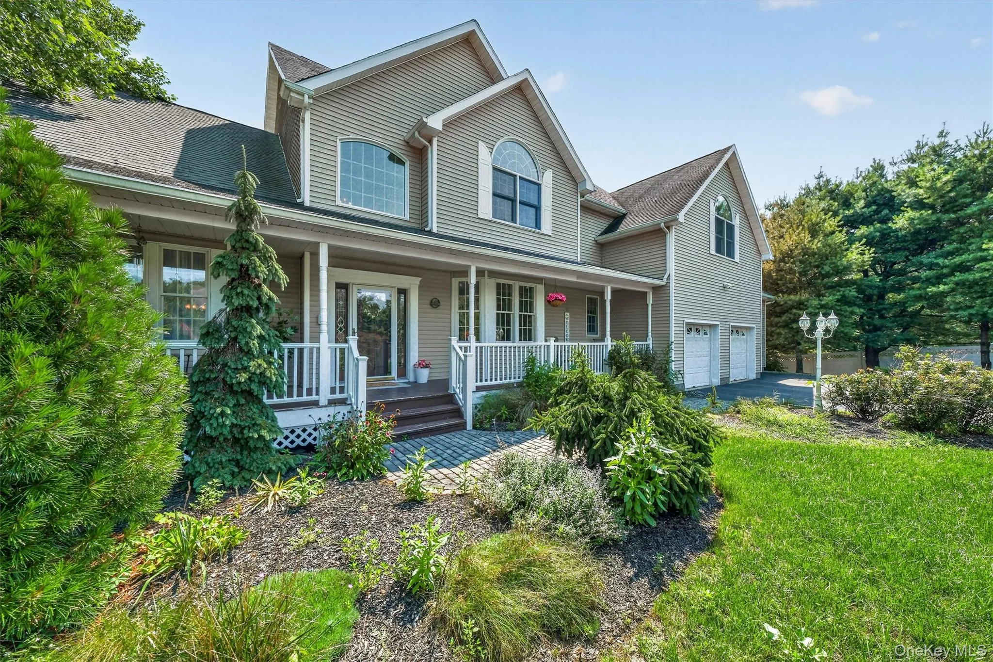 The property is beautifully landscaped with mature trees, lush greenery, and an array of flowering plants. The property is beautifully landscaped with mature trees, lush greenery, and an array of flowering plants.