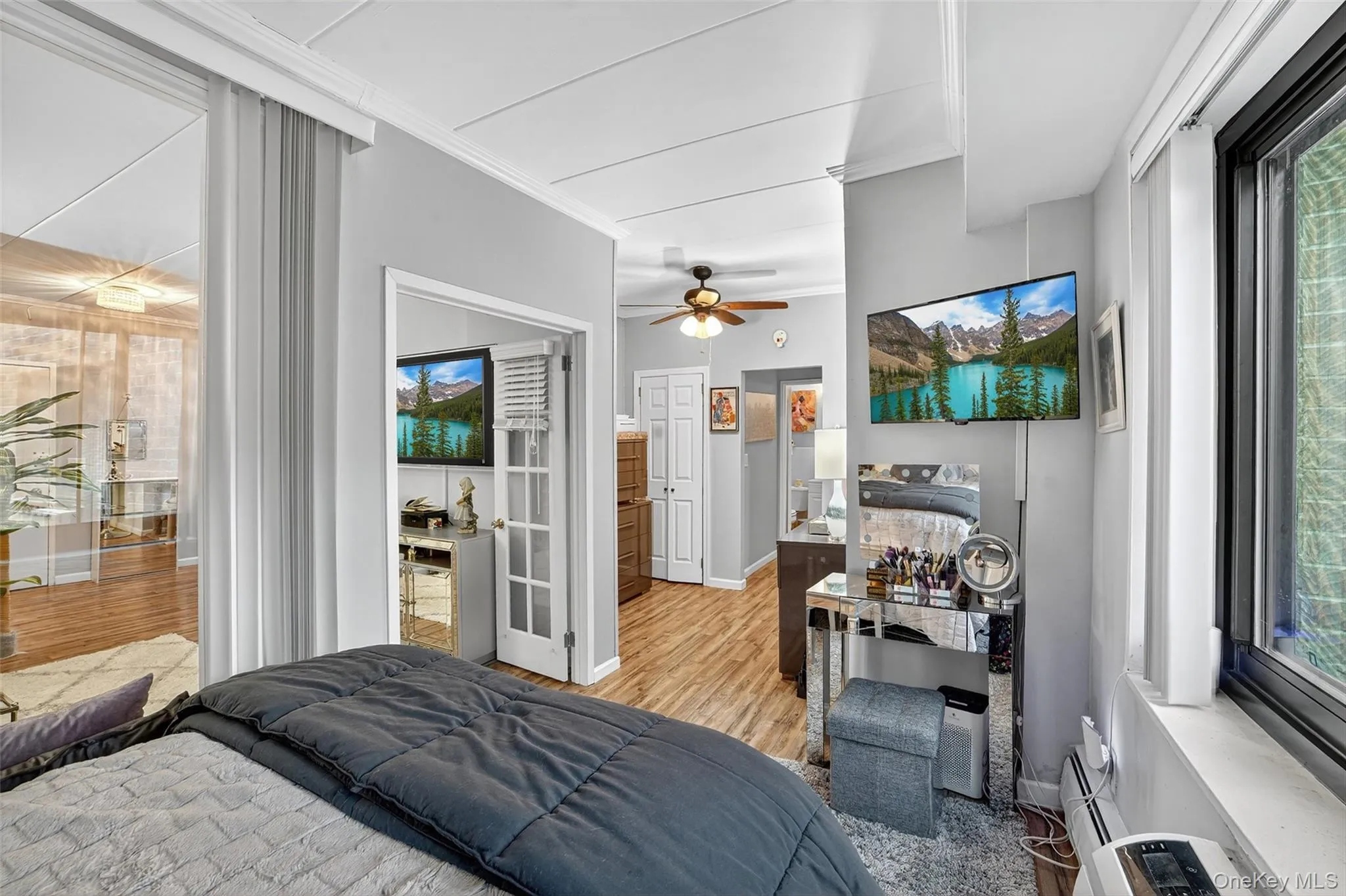 Bedroom featuring crown molding and light wood-type flooring Bedroom featuring crown molding and light wood-type flooring