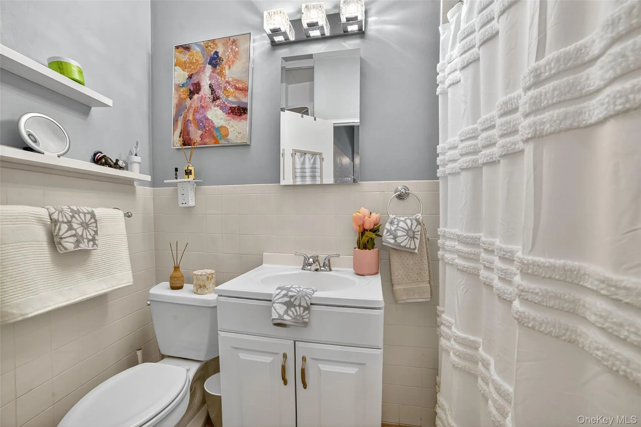 Full bath featuring vanity and tile walls Full bath featuring vanity and tile walls