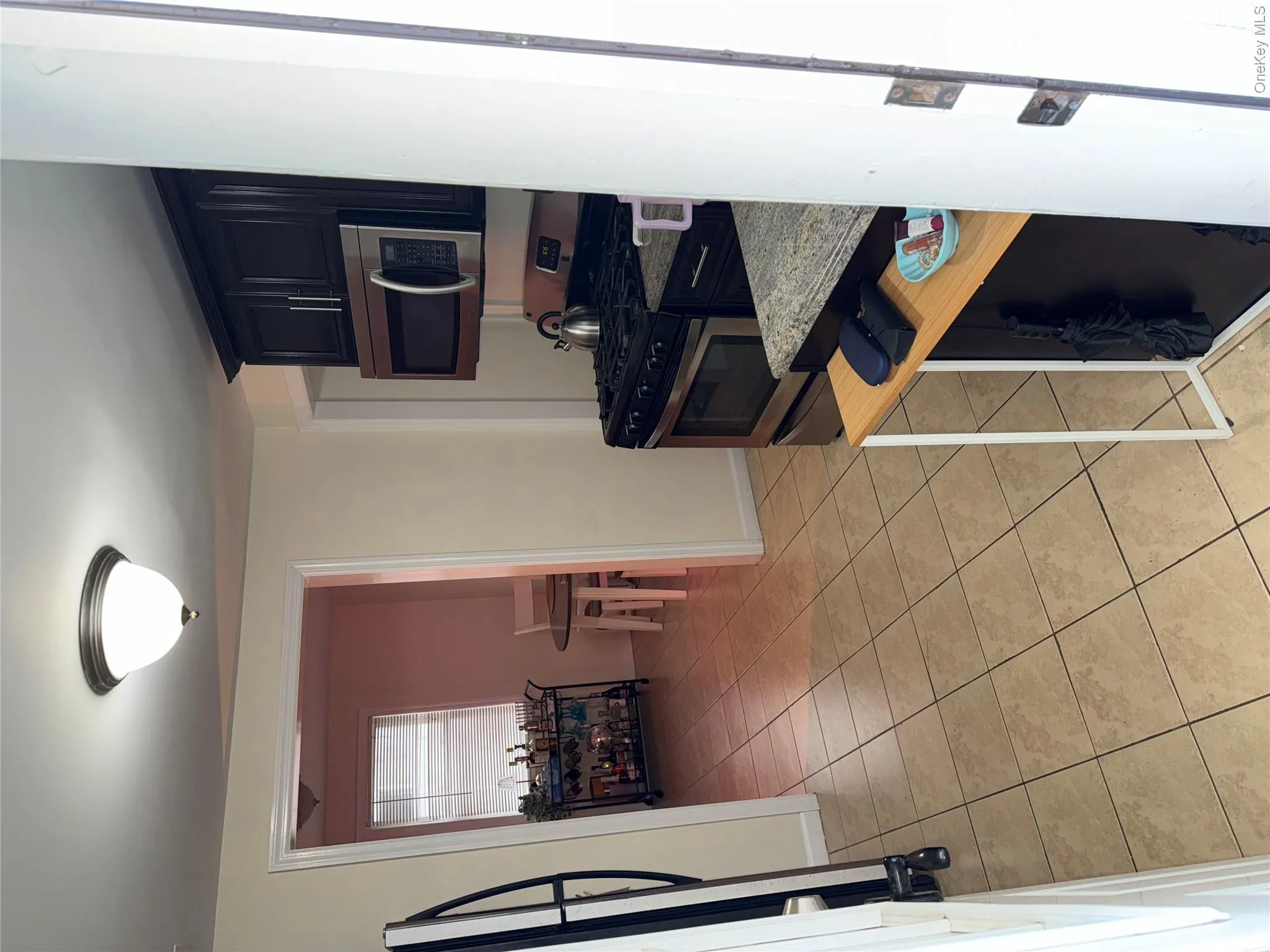 Kitchen with blue cabinetry, baseboards, range, and light tile patterned floors Kitchen with blue cabinetry, baseboards, range, and light tile patterned floors