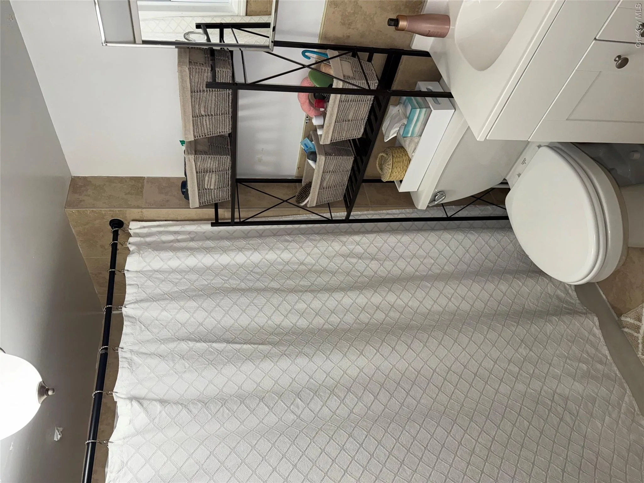 Bathroom with a shower with curtain, toilet, and vanity Bathroom with a shower with curtain, toilet, and vanity