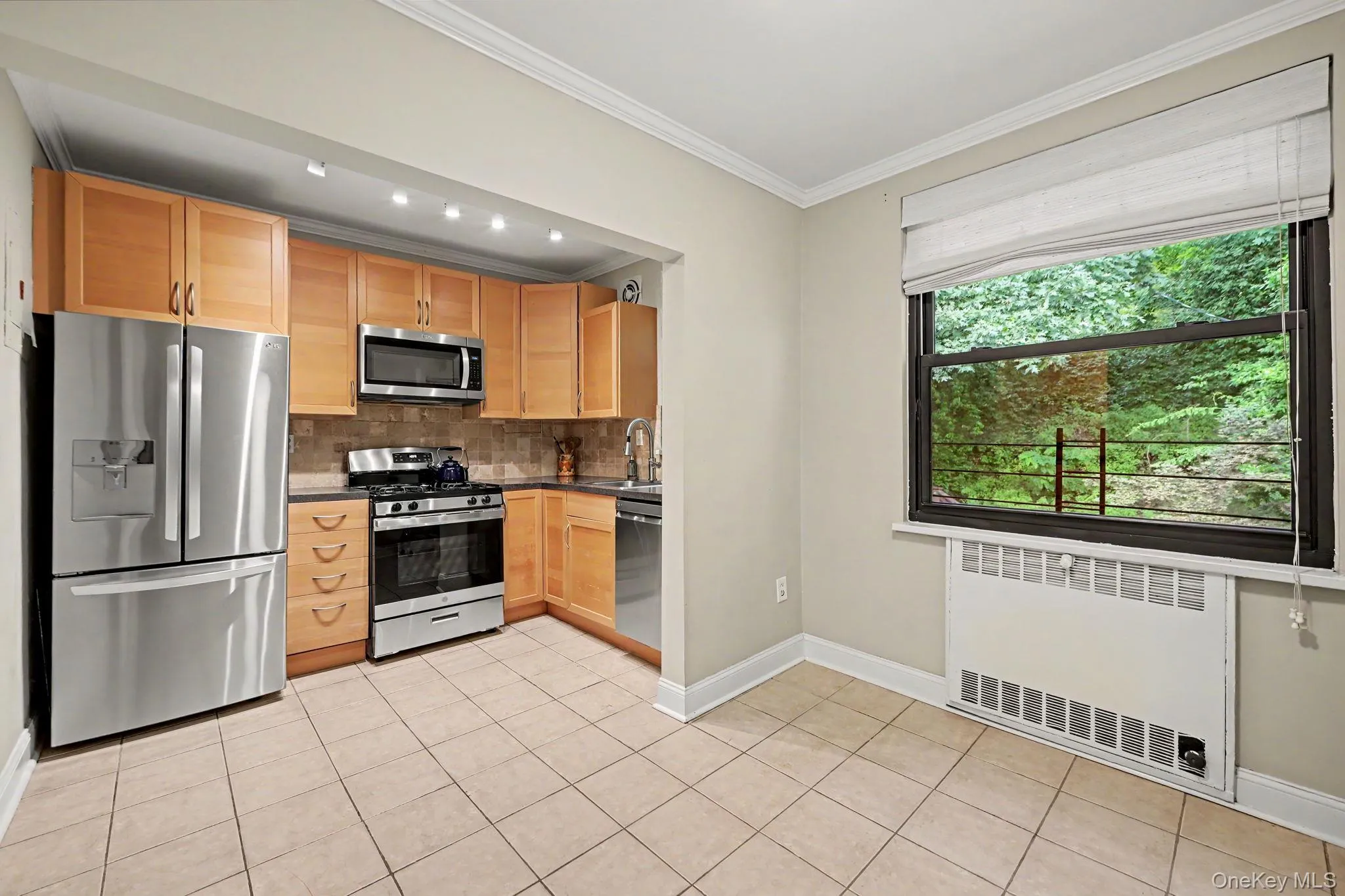 Kitchen open to large windowed dining room. Kitchen open to large windowed dining room.