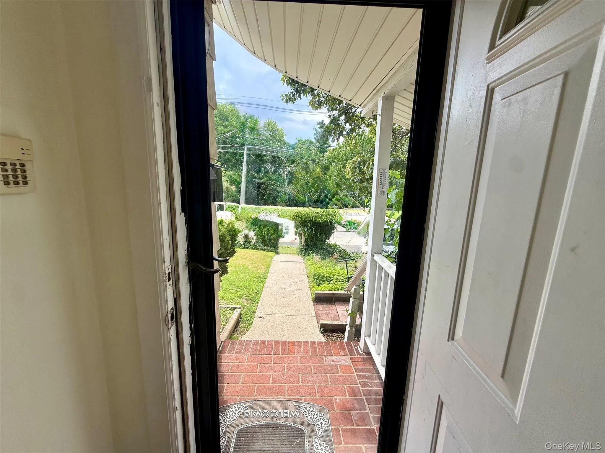 Front entrance featuring a white panel door and an exterior brick landing Front entrance featuring a white panel door and an exterior brick landing