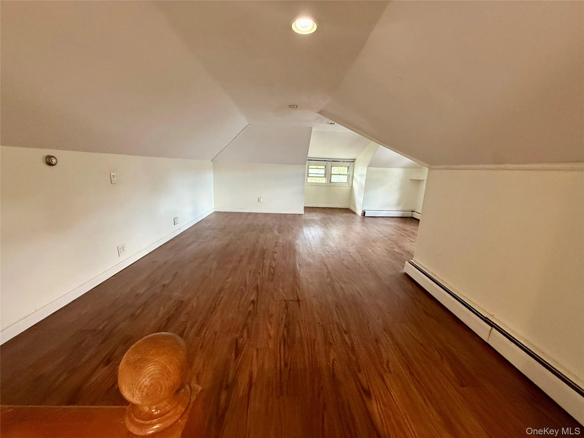 Second Floor, Third Bedroom, featuring wood-finish flooring, multiple windows, and baseboard heating Second Floor, Third Bedroom, featuring wood-finish flooring, multiple windows, and baseboard heating