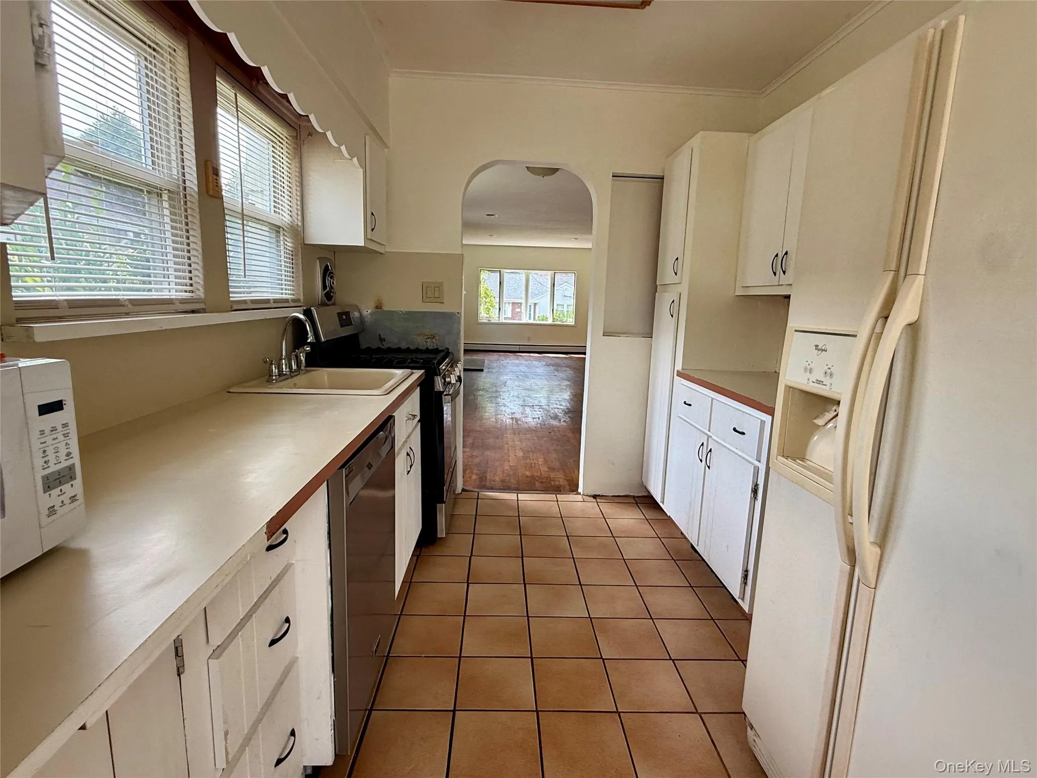 Galley kitchen with gas range, dishwasher and fridge Galley kitchen with gas range, dishwasher and fridge