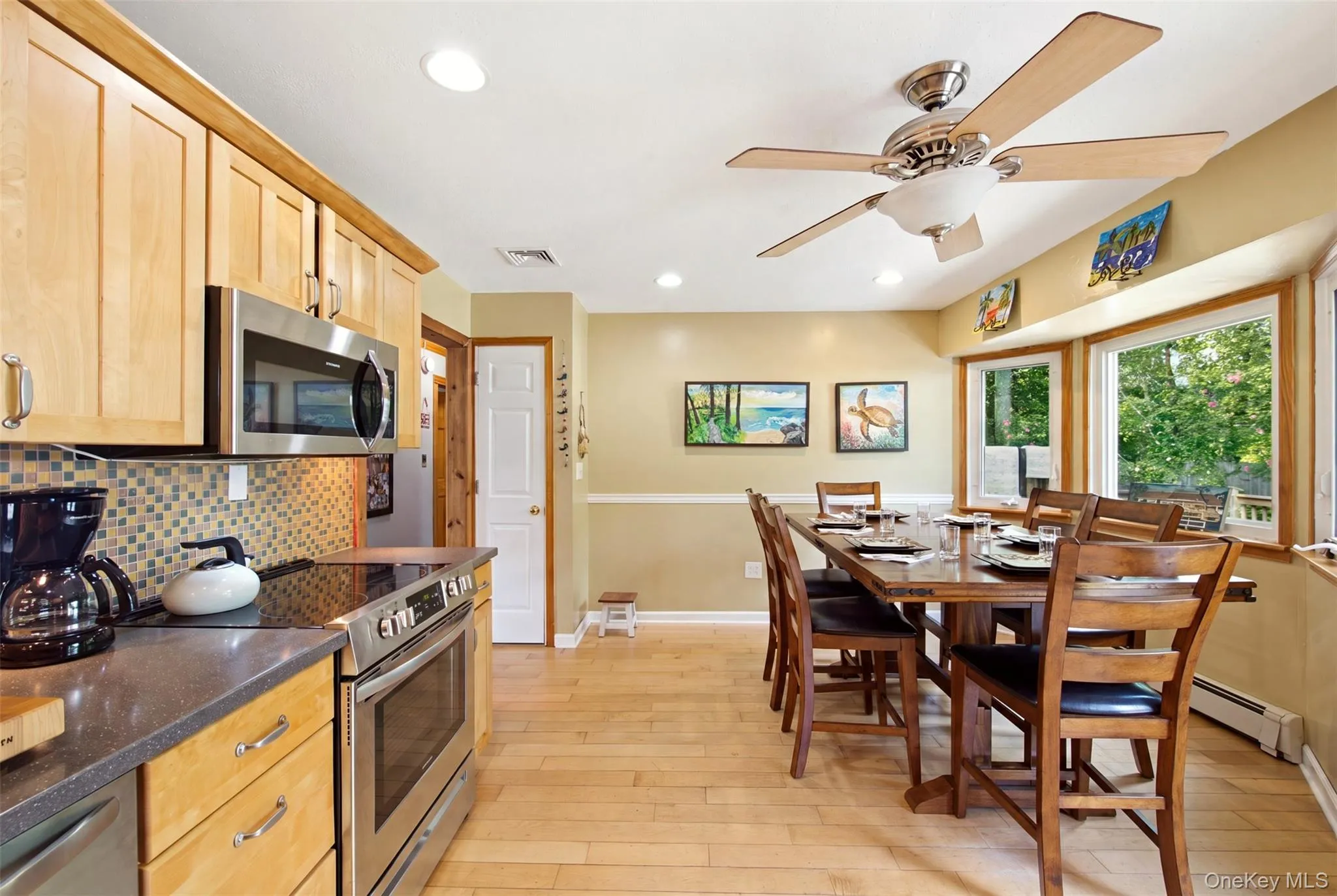 A bright eat- in Kitchen space with Glass sliders to the yard. A bright eat- in Kitchen space with Glass sliders to the yard.