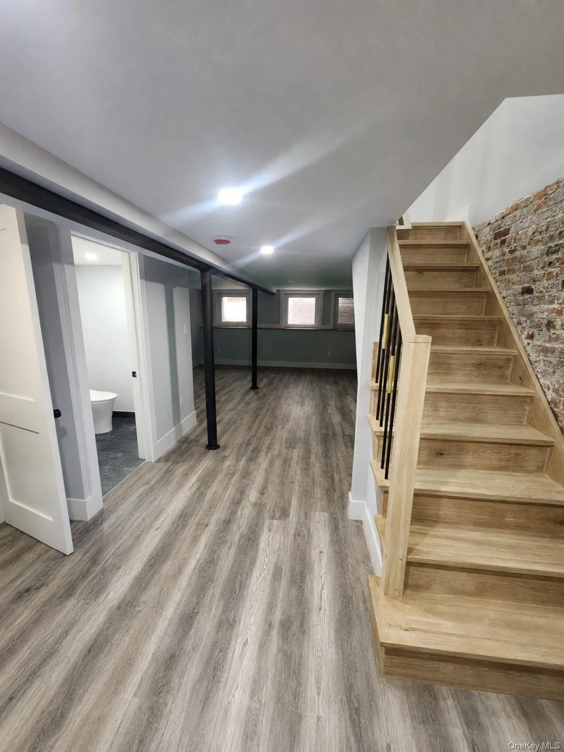 Finished lower level featuring wood-finish flooring, recessed lighting, and a white trim package Finished lower level featuring wood-finish flooring, recessed lighting, and a white trim package
