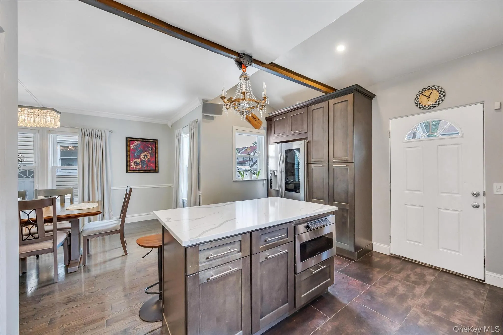 Kitchen island with white countertop, integrated microwave, and ample storage Kitchen island with white countertop, integrated microwave, and ample storage