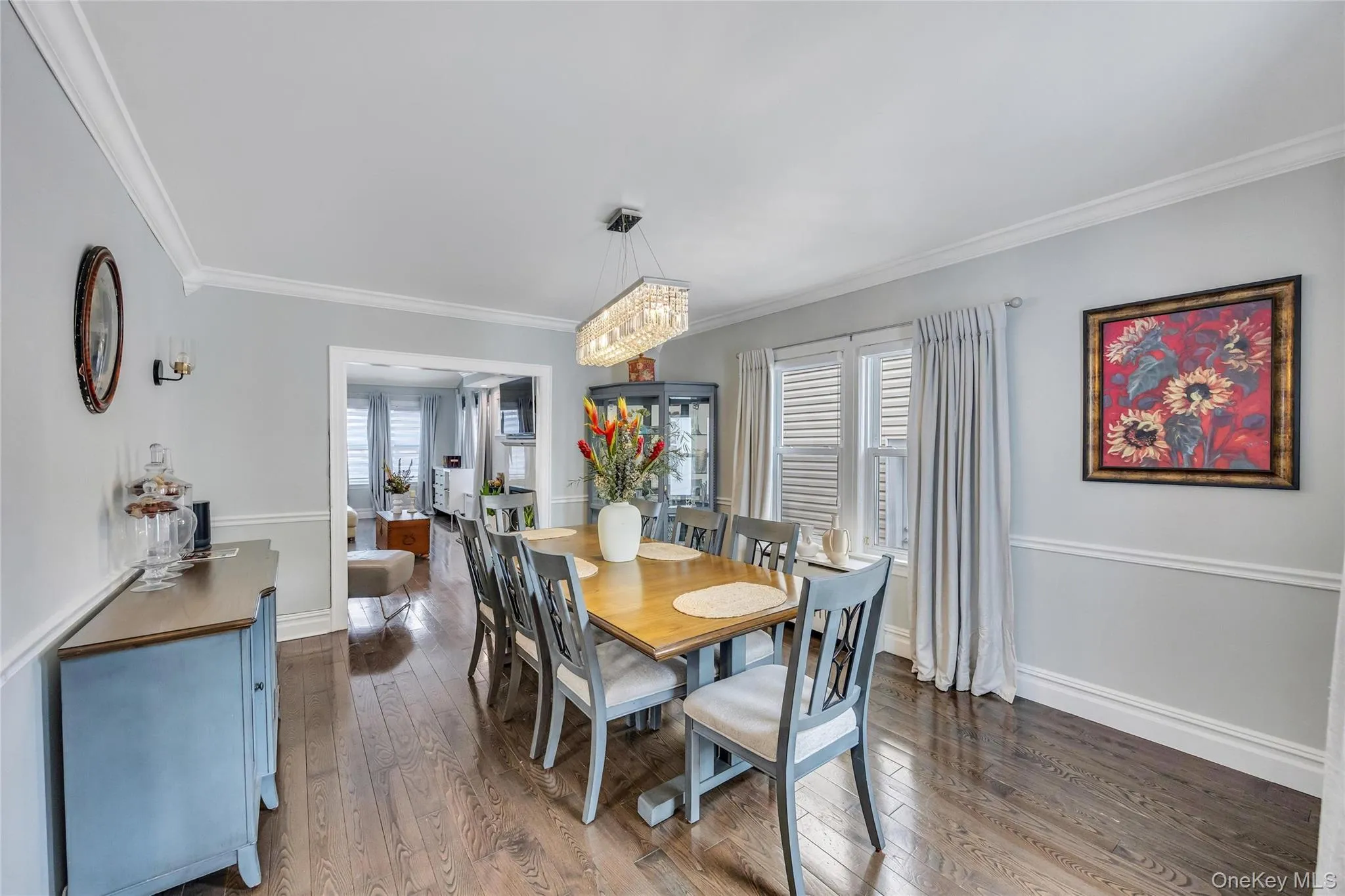 Hardwood flooring extending throughout, complemented by crown molding and wainscoting Hardwood flooring extending throughout, complemented by crown molding and wainscoting