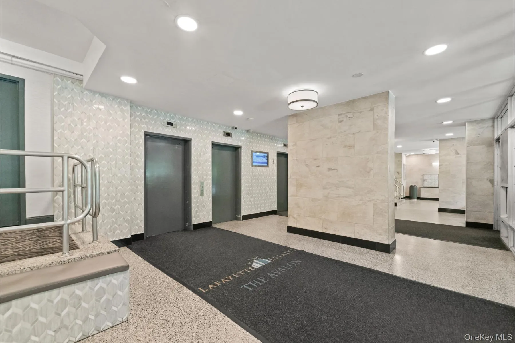 Lobby entrance featuring two elevators, recessed ceiling lighting, textured wall finishes, and a terrazzo-style floor Lobby entrance featuring two elevators, recessed ceiling lighting, textured wall finishes, and a terrazzo-style floor