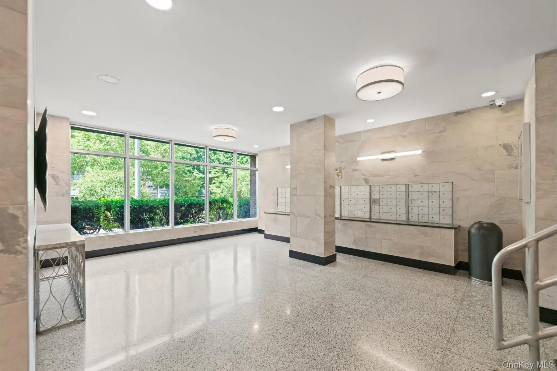 Lobby entrance featuring full-height windows, recessed lighting, and a drum ceiling fixture Lobby entrance featuring full-height windows, recessed lighting, and a drum ceiling fixture