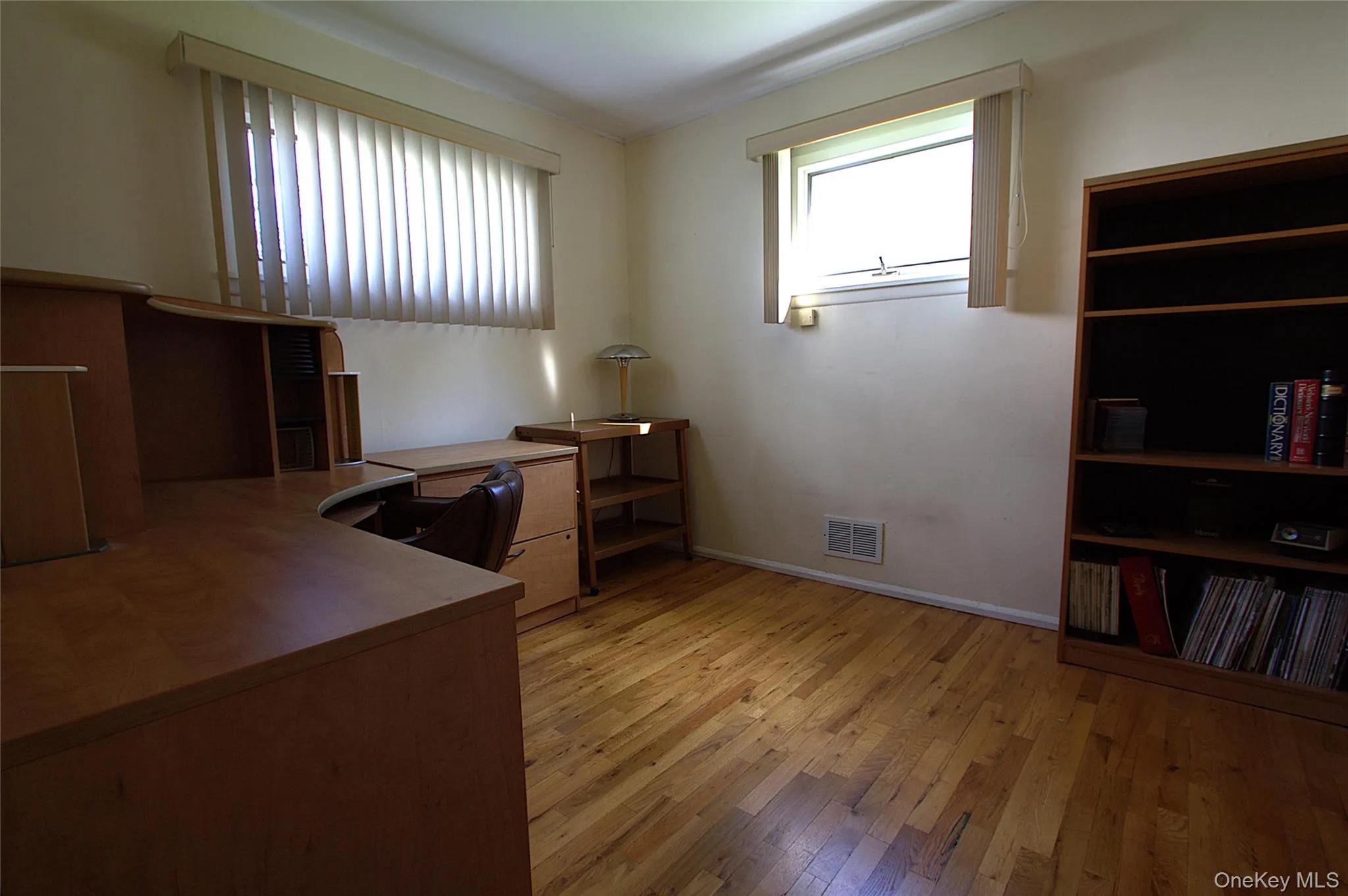 1st Floor Bedroom, Hardwood flooring, painted walls, and multiple windows 1st Floor Bedroom, Hardwood flooring, painted walls, and multiple windows