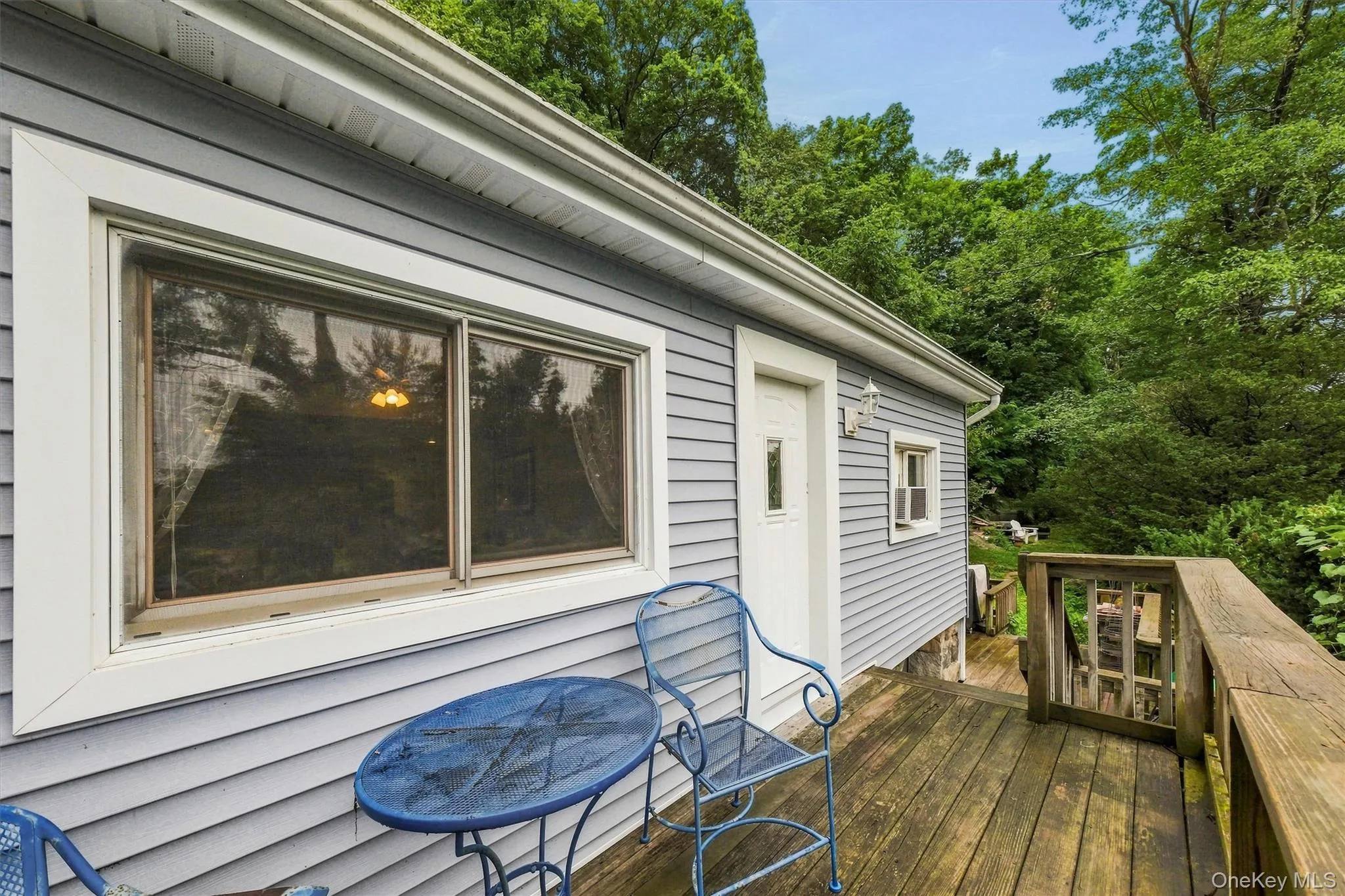 Exterior siding in a soft blue hue, featuring white trim. Lake views from this spot Exterior siding in a soft blue hue, featuring white trim. Lake views from this spot