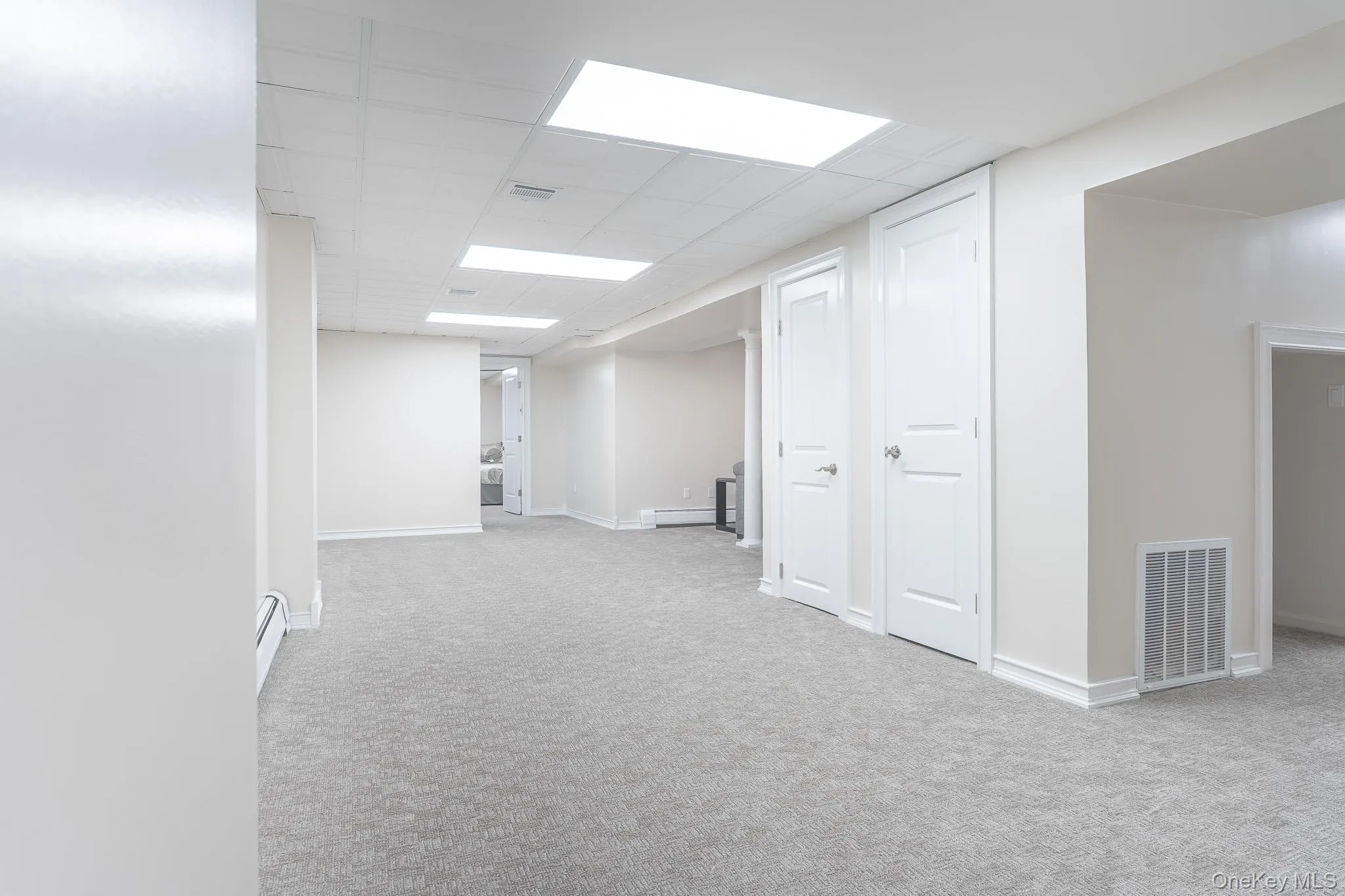 Spacious open floor plan with neutral carpet flooring, recessed ceiling lighting, and clean white wall finishes Spacious open floor plan with neutral carpet flooring, recessed ceiling lighting, and clean white wall finishes