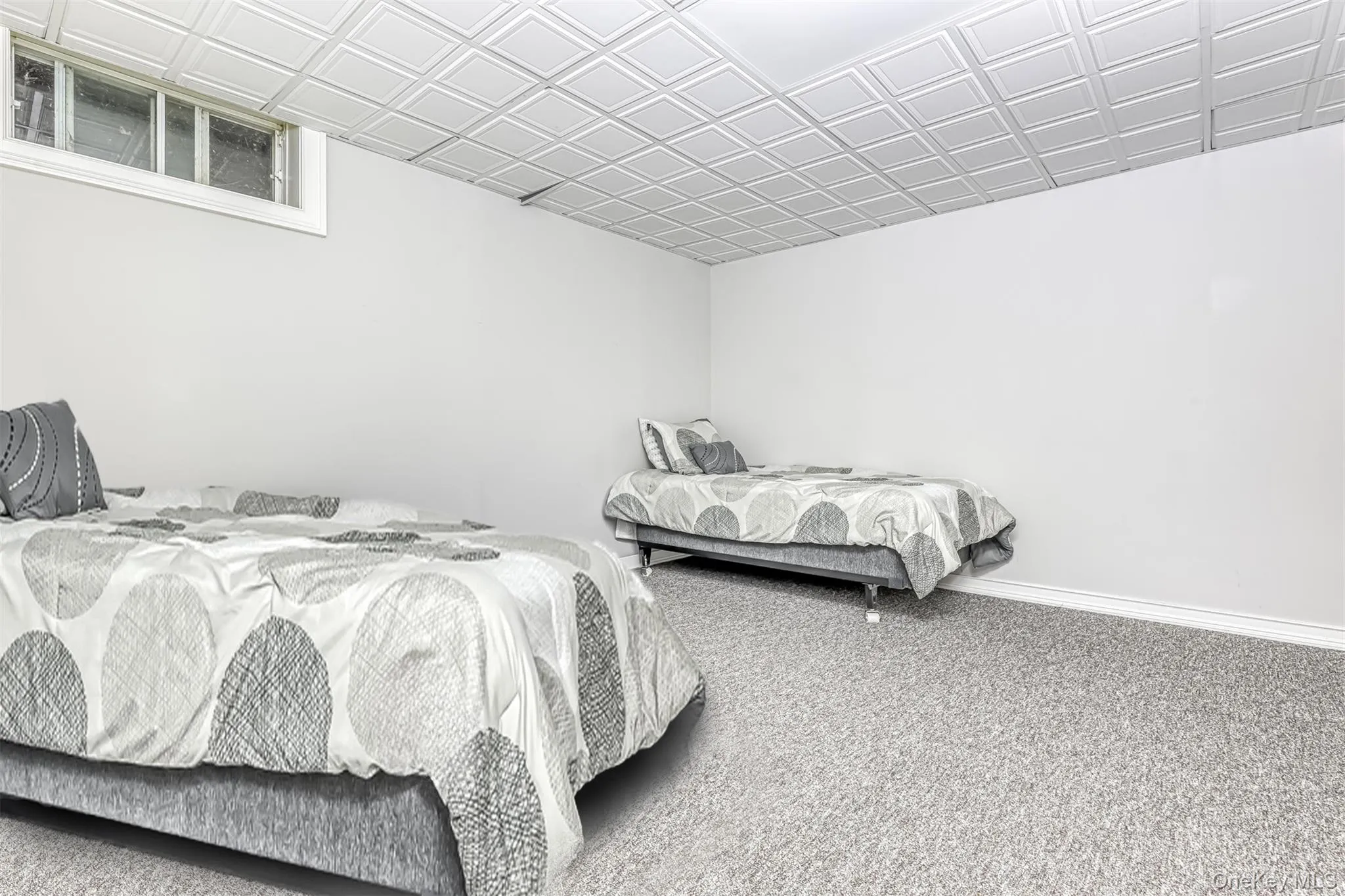 Spacious room featuring light gray carpeting, crisp white walls, and a recessed window Spacious room featuring light gray carpeting, crisp white walls, and a recessed window