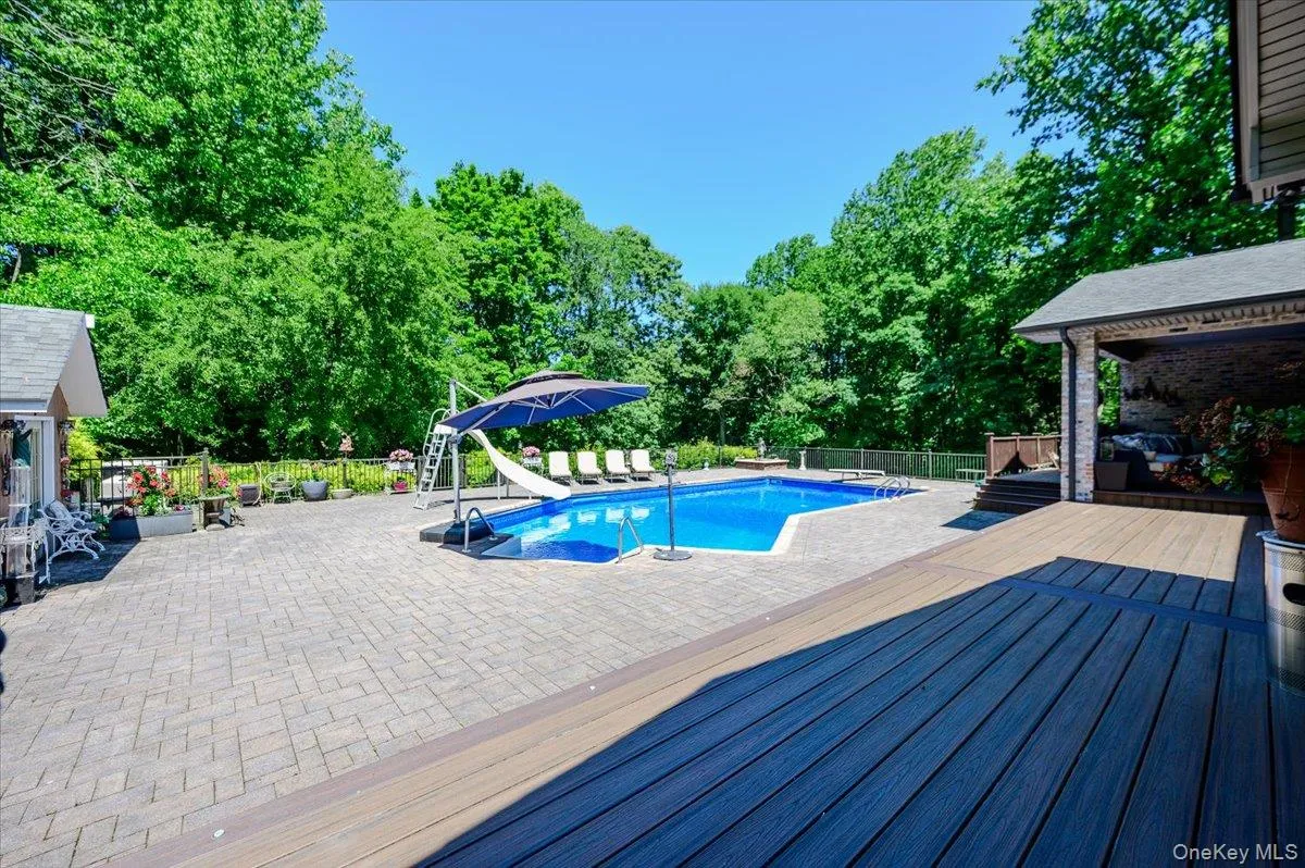 Pool surrounded by Paver Patio Pool surrounded by Paver Patio
