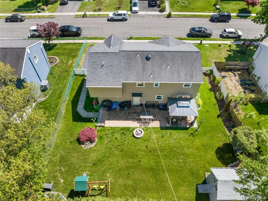 Expansive rear yard featuring a paved patio area, covered gazebo, and a fire pit Expansive rear yard featuring a paved patio area, covered gazebo, and a fire pit