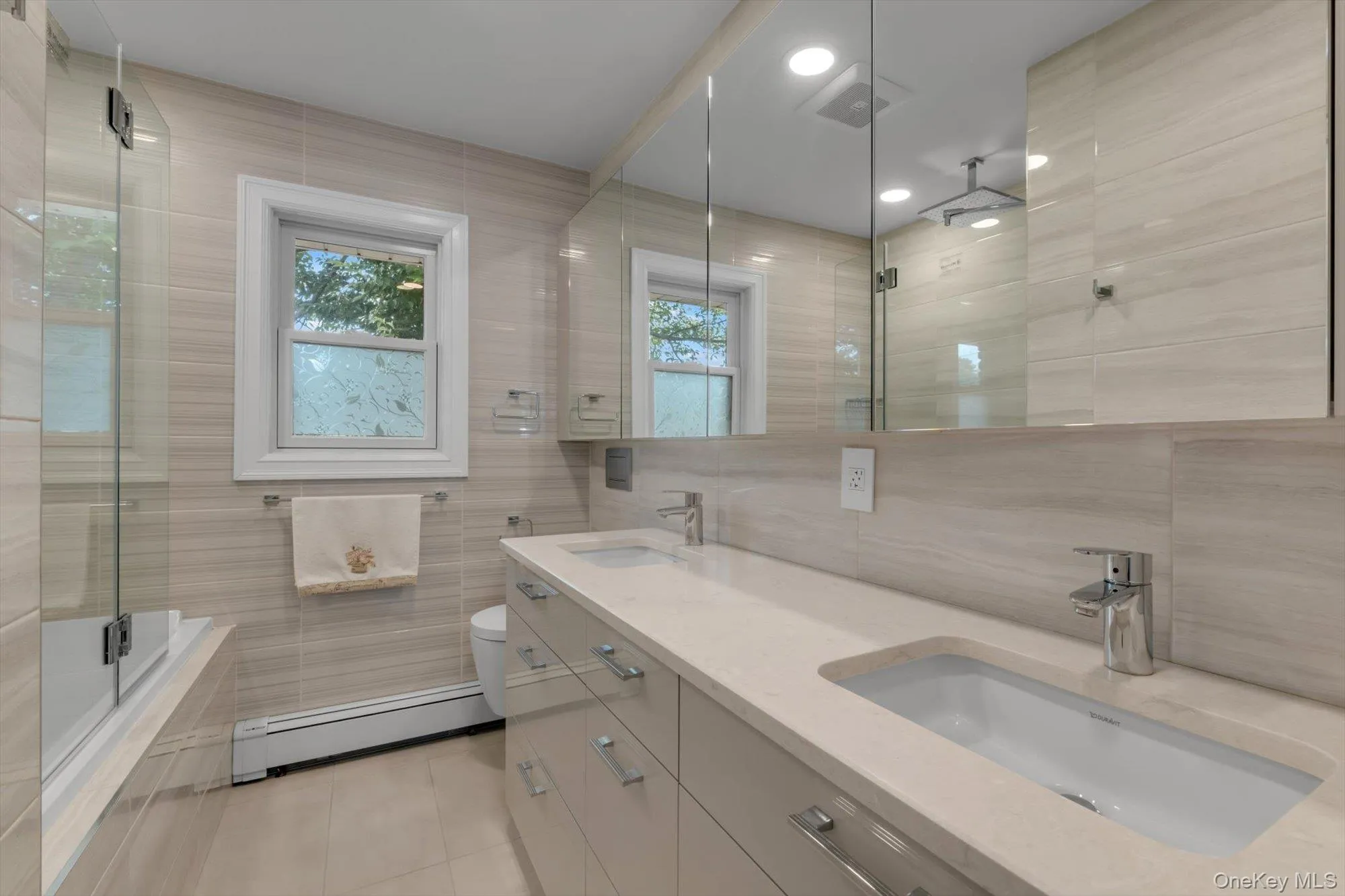 Bathroom with custom German vanity with two sinks and designer fixtures Bathroom with custom German vanity with two sinks and designer fixtures