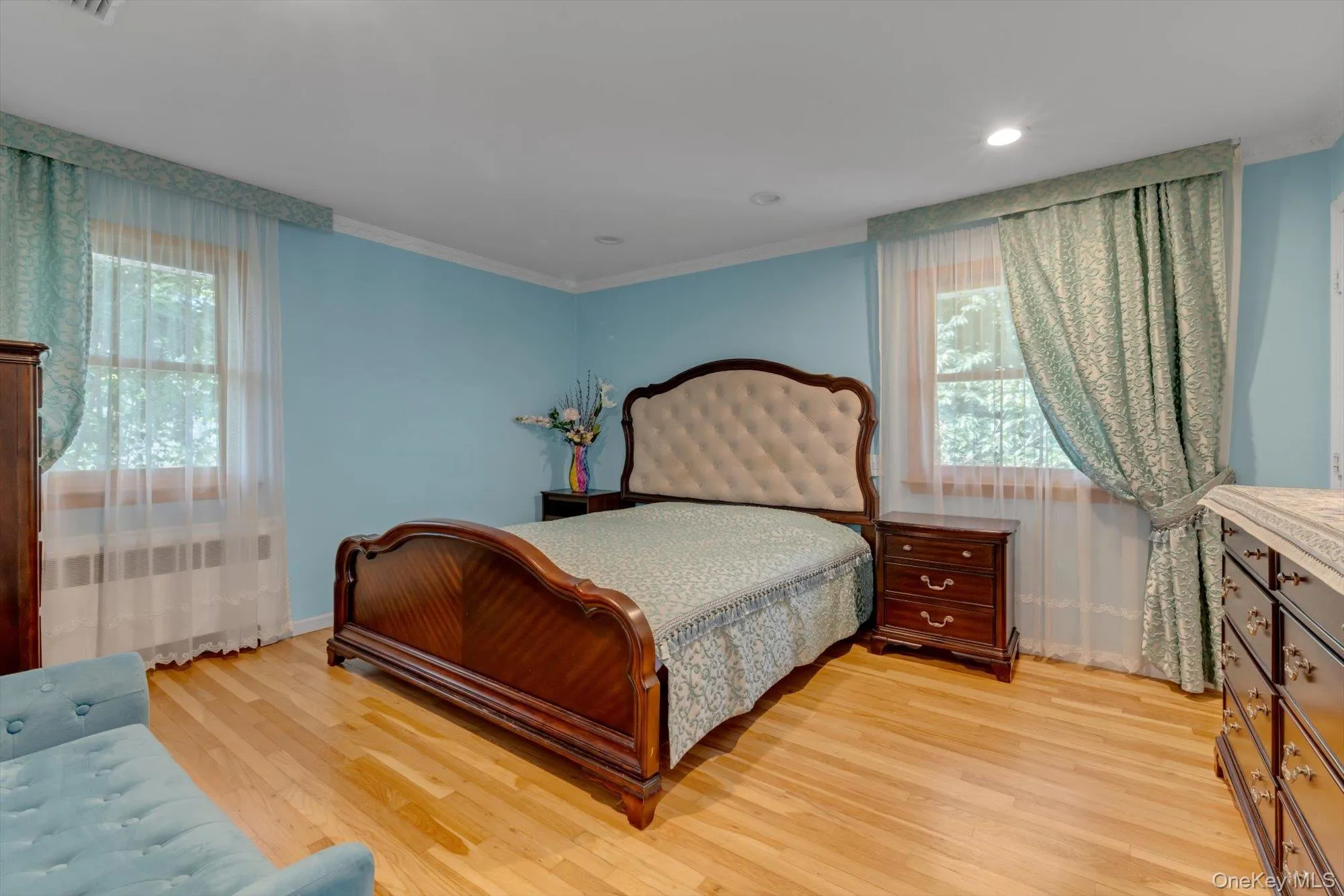 Primary bedroom with Hardwood flooring, recessed lighting, and crown molding Primary bedroom with Hardwood flooring, recessed lighting, and crown molding