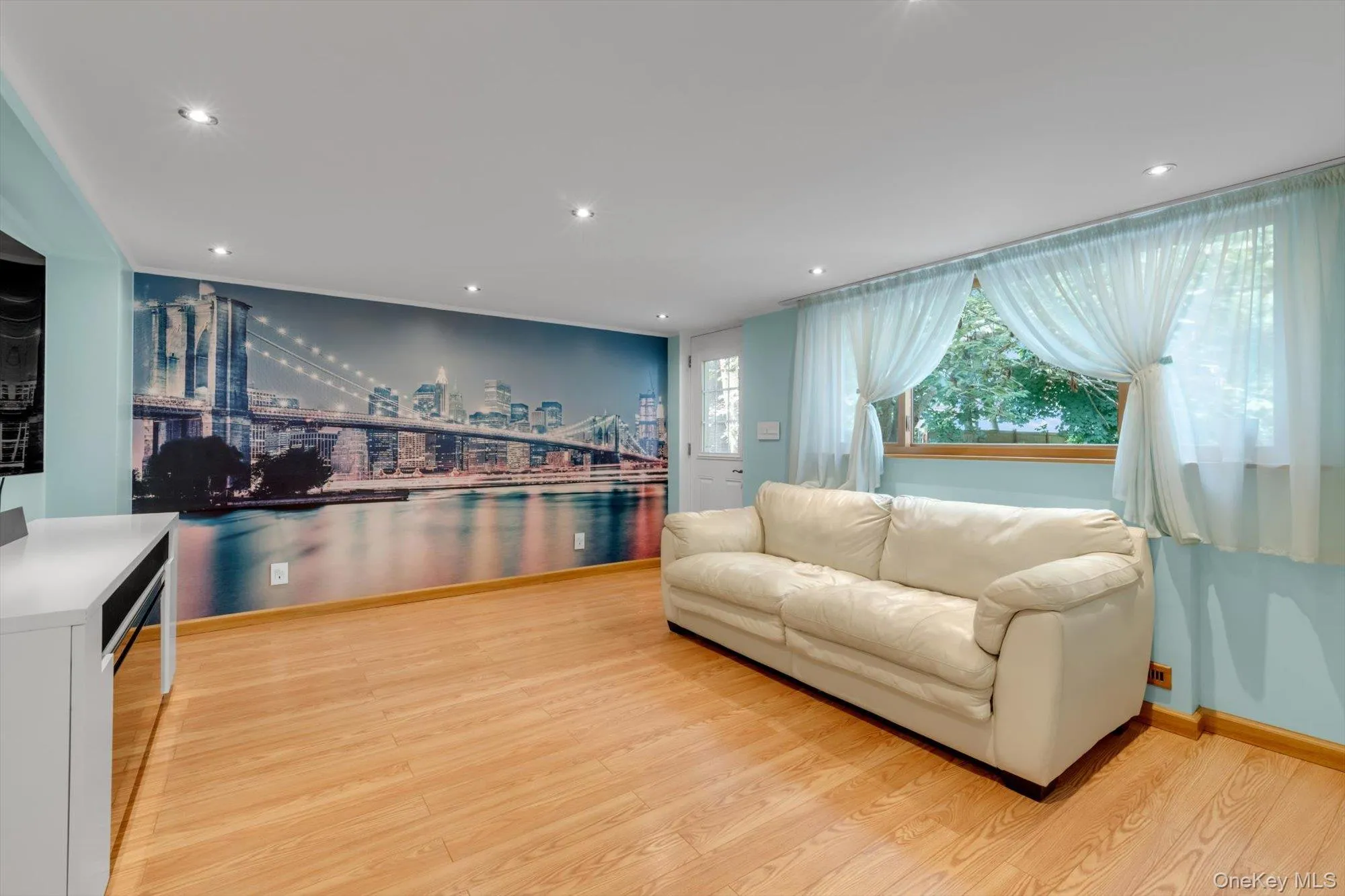 Recessed lighting, wood-finish flooring, and large window overlooking scenic backyard Recessed lighting, wood-finish flooring, and large window overlooking scenic backyard