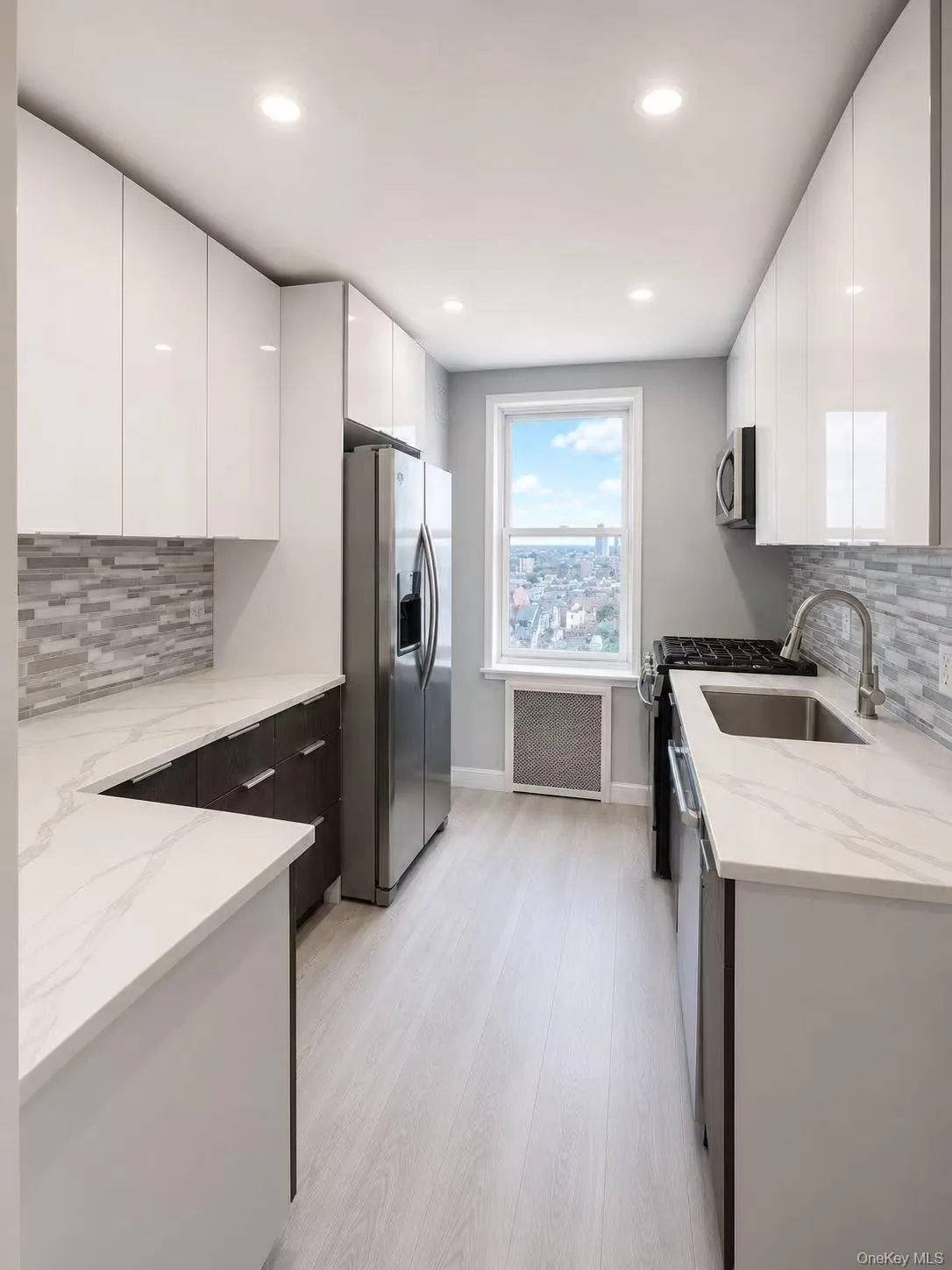 Modern galley kitchen featuring light wood-finish flooring, white gloss cabinetry, and patterned countertops Modern galley kitchen featuring light wood-finish flooring, white gloss cabinetry, and patterned countertops