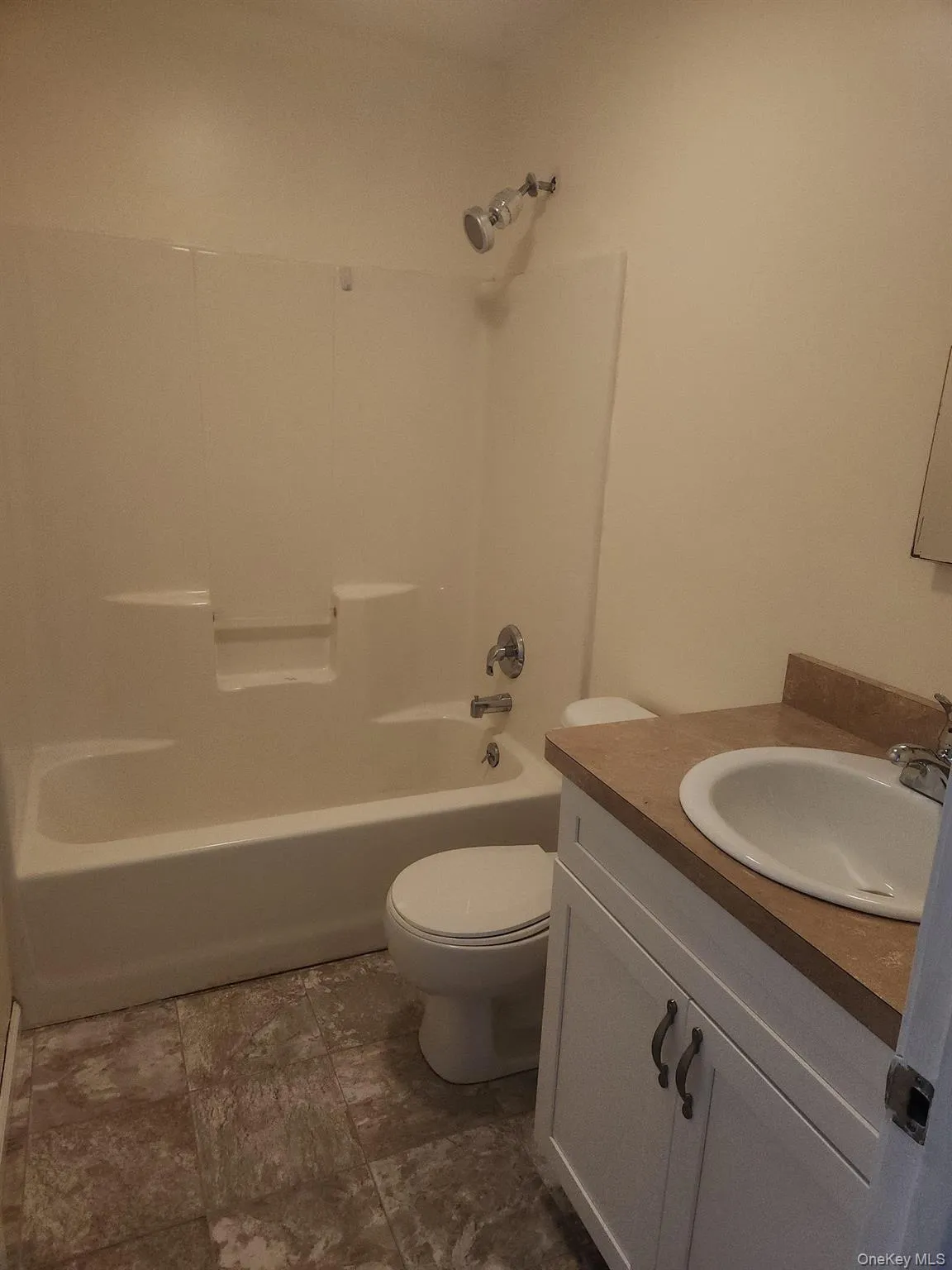 This full bath is located on the second floor. A small half bath is located just off the kitchen. This full bath is located on the second floor. A small half bath is located just off the kitchen.
