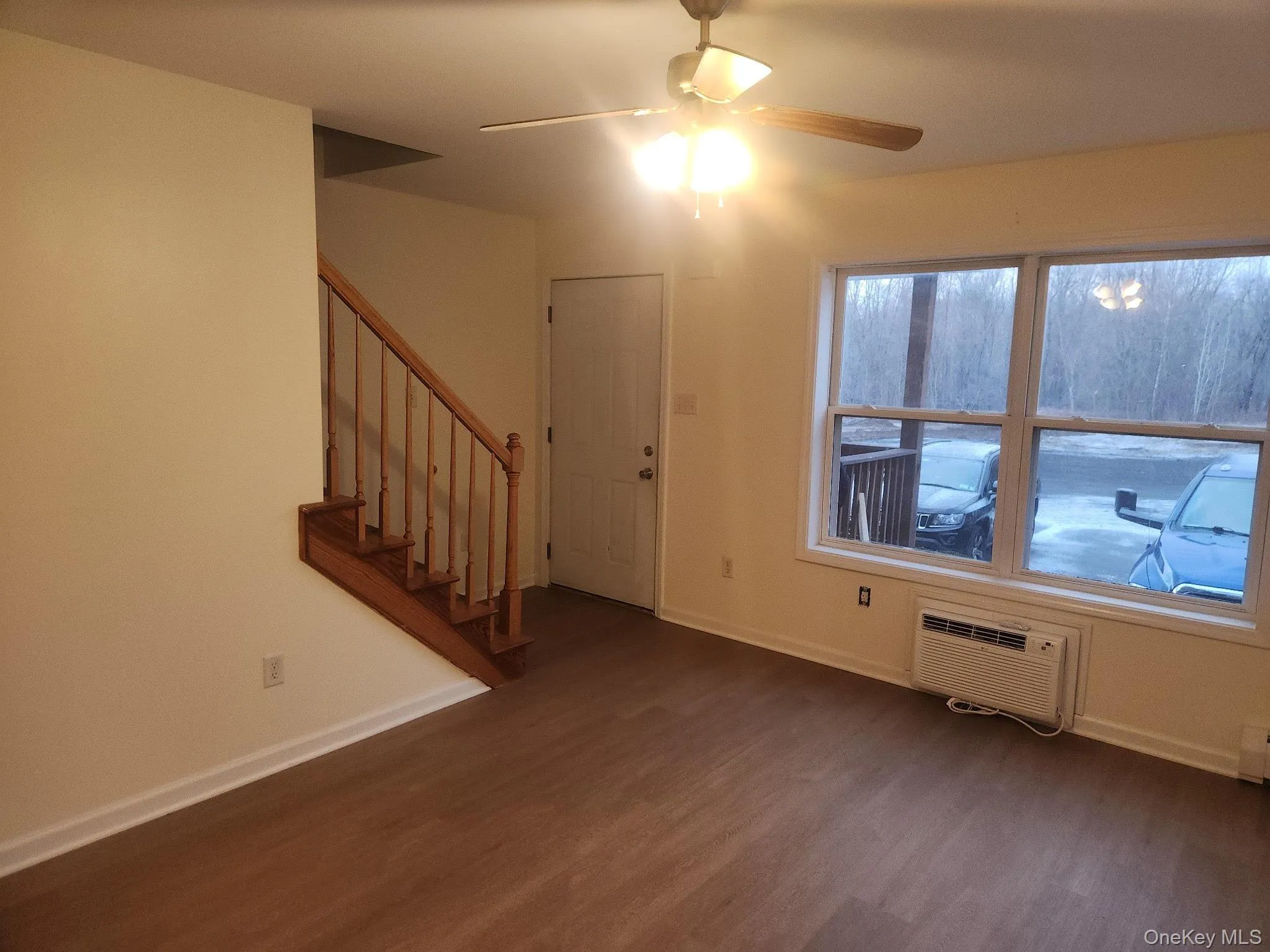 An A/C wall unit and ceiling fan offer this northern facing living area comfort on sunny days. An A/C wall unit and ceiling fan offer this northern facing living area comfort on sunny days.
