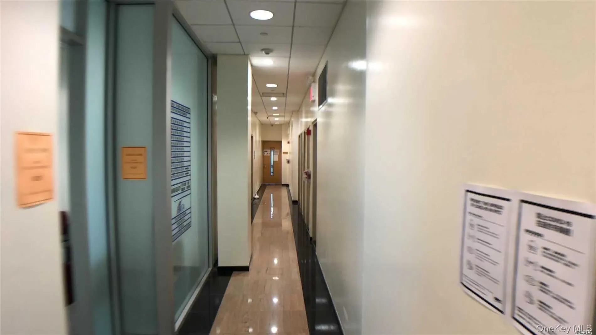 Hall with a paneled ceiling, baseboards, and recessed lighting Hall with a paneled ceiling, baseboards, and recessed lighting