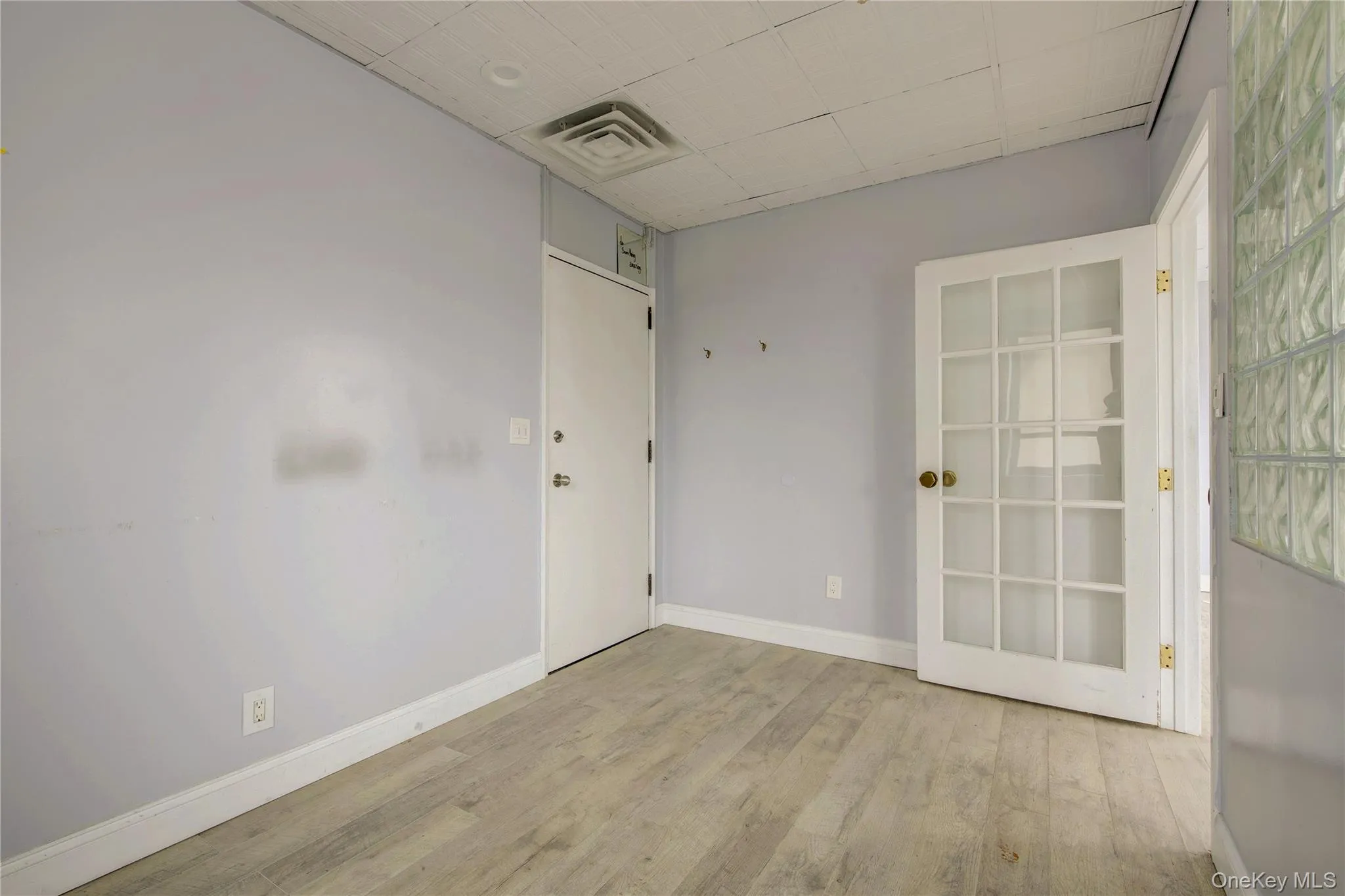 Unfurnished room with wood finished floors and baseboards Unfurnished room with wood finished floors and baseboards