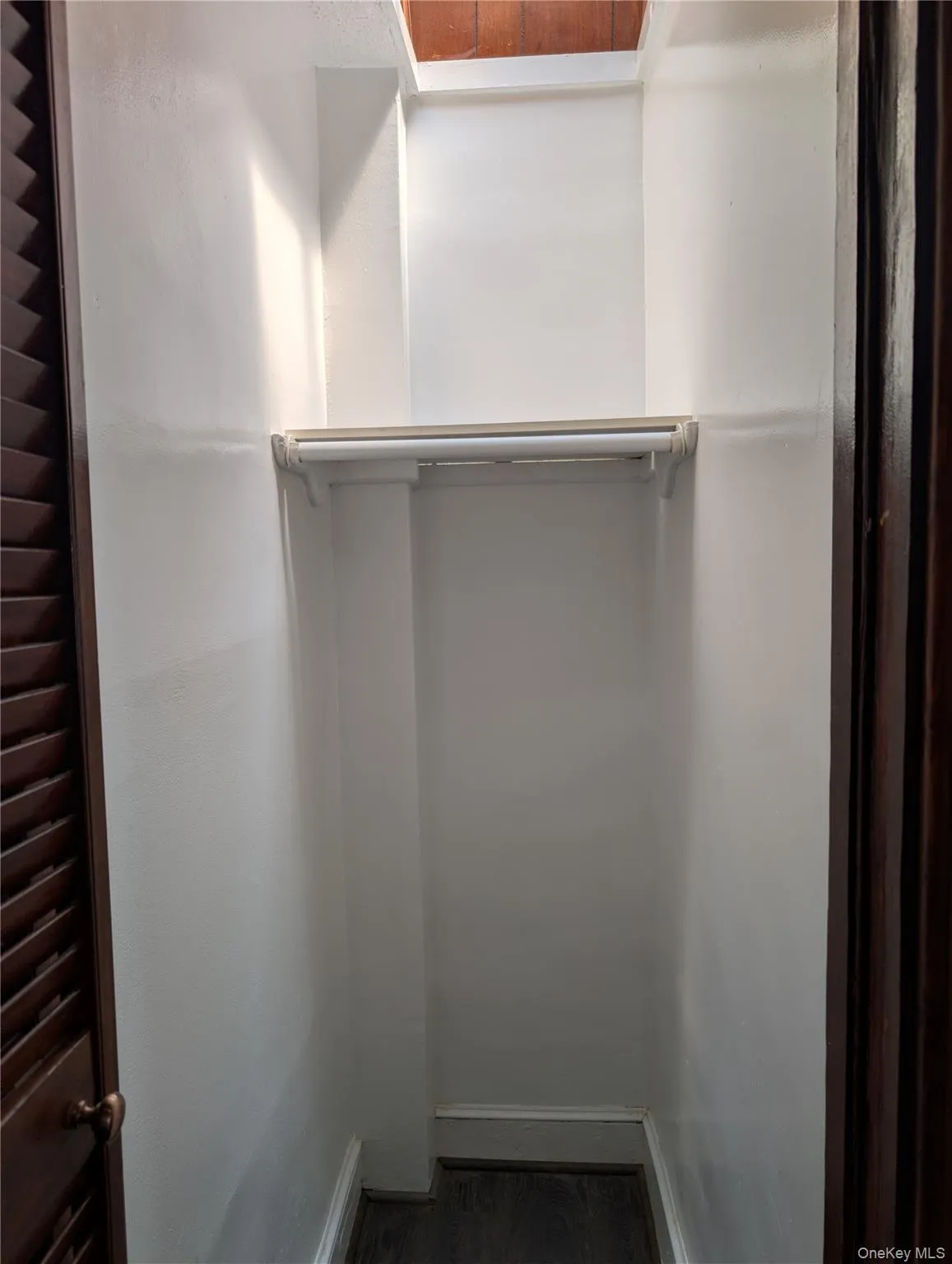 Walk-in hall closet with bi-fold doors and skylight Walk-in hall closet with bi-fold doors and skylight