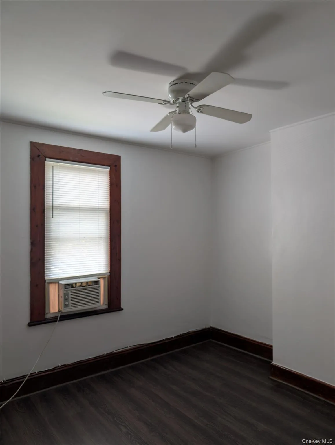 Second bedroom with ceiling fan/light combination, vinyl flooring and window A/C unit Second bedroom with ceiling fan/light combination, vinyl flooring and window A/C unit