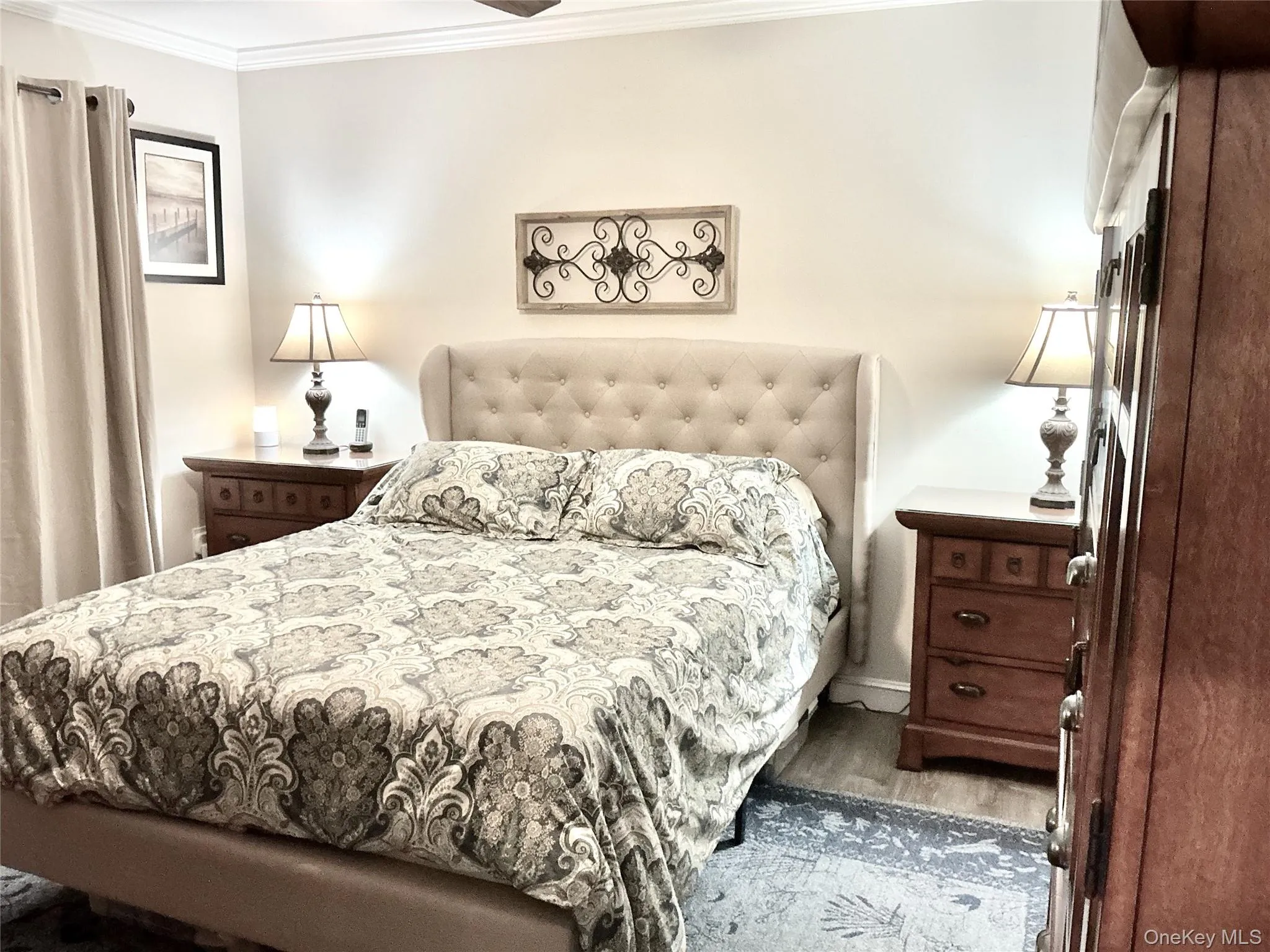 Light-toned walls with crown molding, wood-finish flooring. Light-toned walls with crown molding, wood-finish flooring.