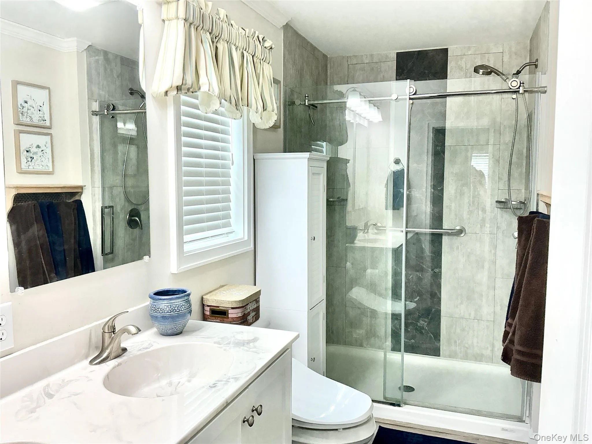 Vanity with integrated sink, brushed nickel faucet, and a large mirror Vanity with integrated sink, brushed nickel faucet, and a large mirror