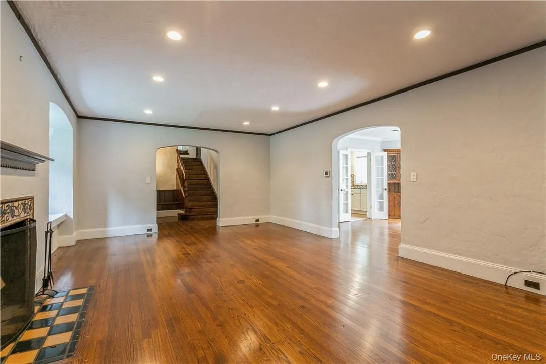 Living room with a fireplace. Archway to the right leads to the dining room. Living room with a fireplace. Archway to the right leads to the dining room.